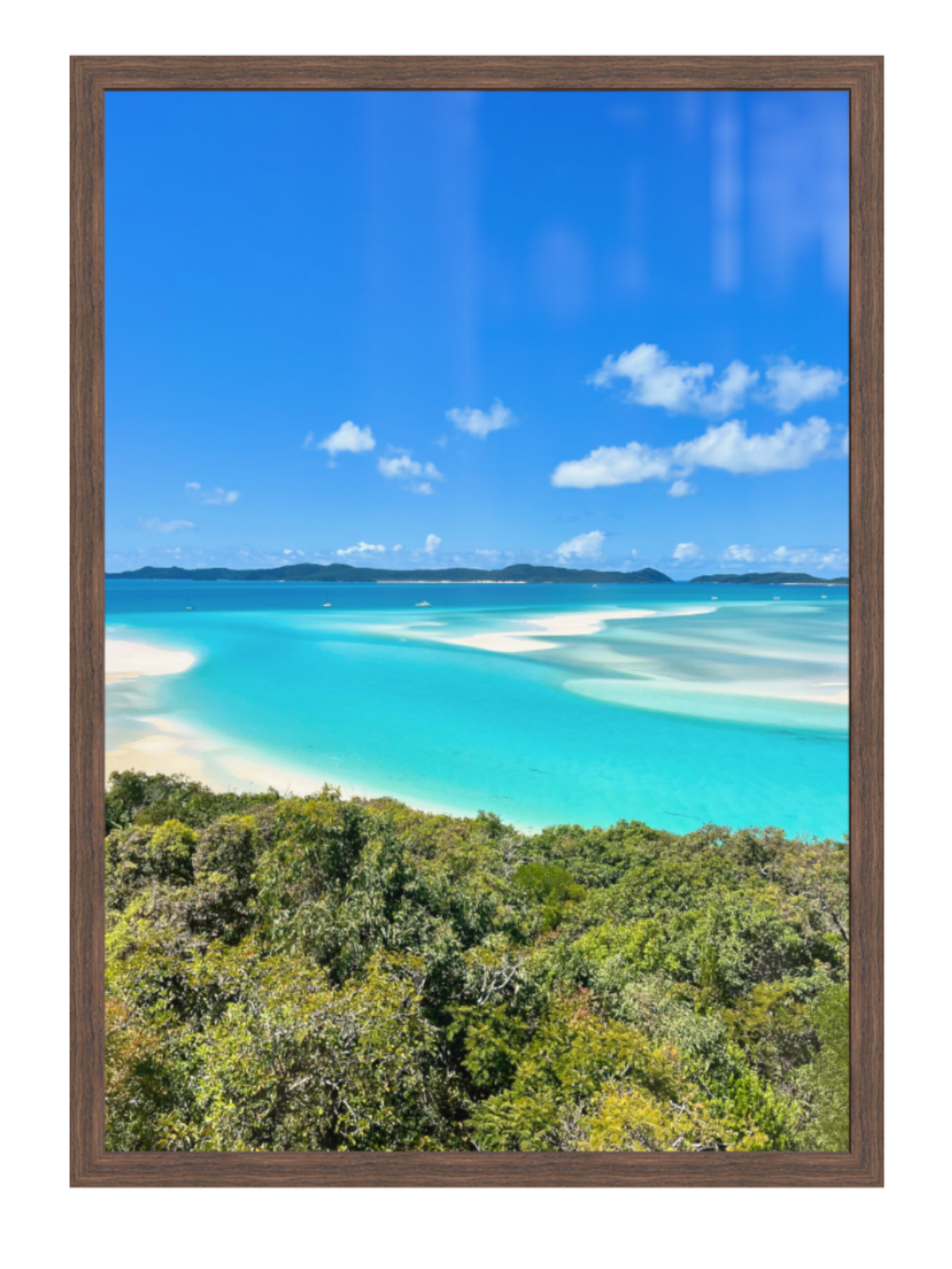 Framed artwork of a tropical beach with turquoise water and blue sky.