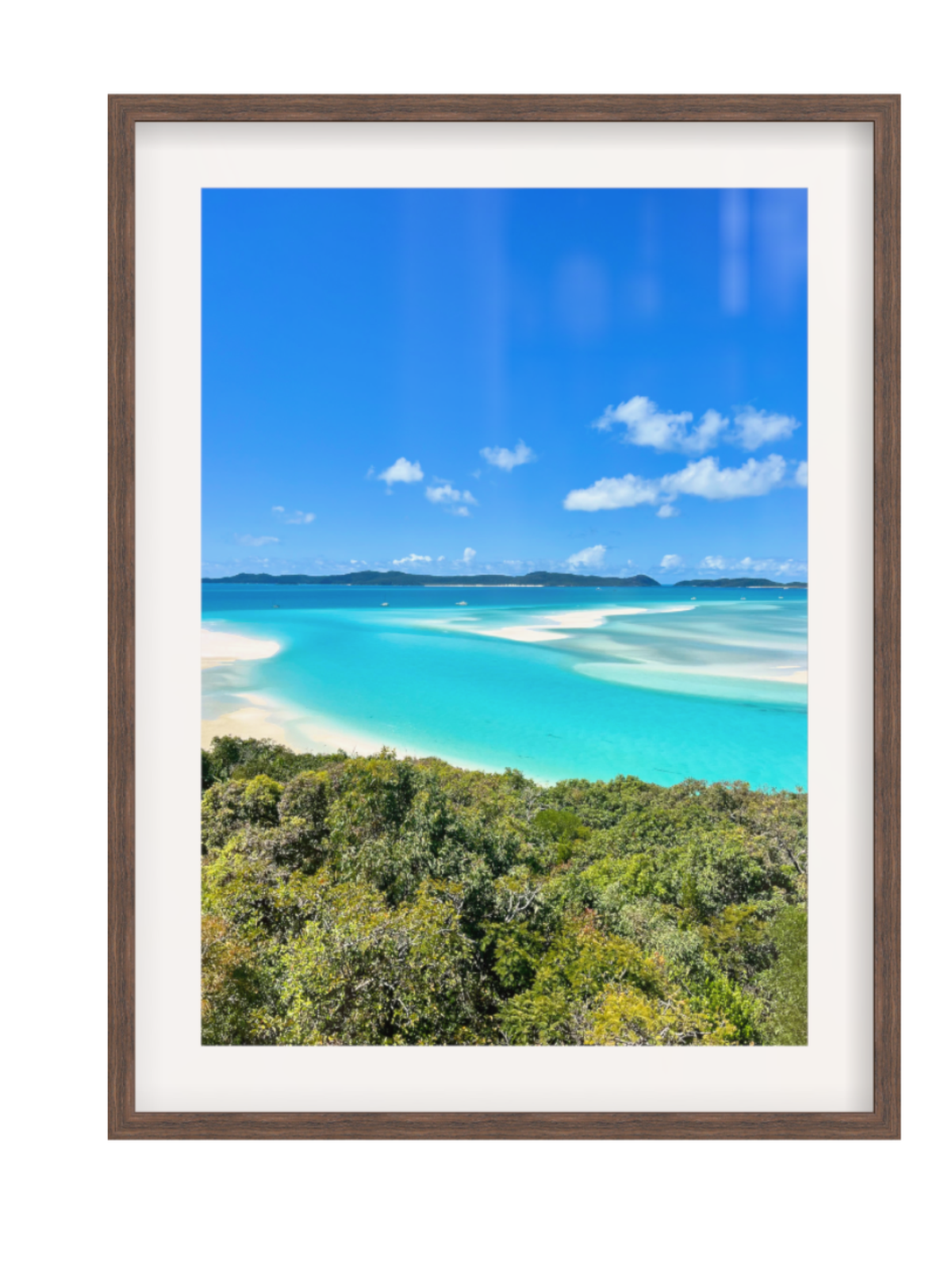 Framed photograph of a tropical beach with turquoise water and blue sky.