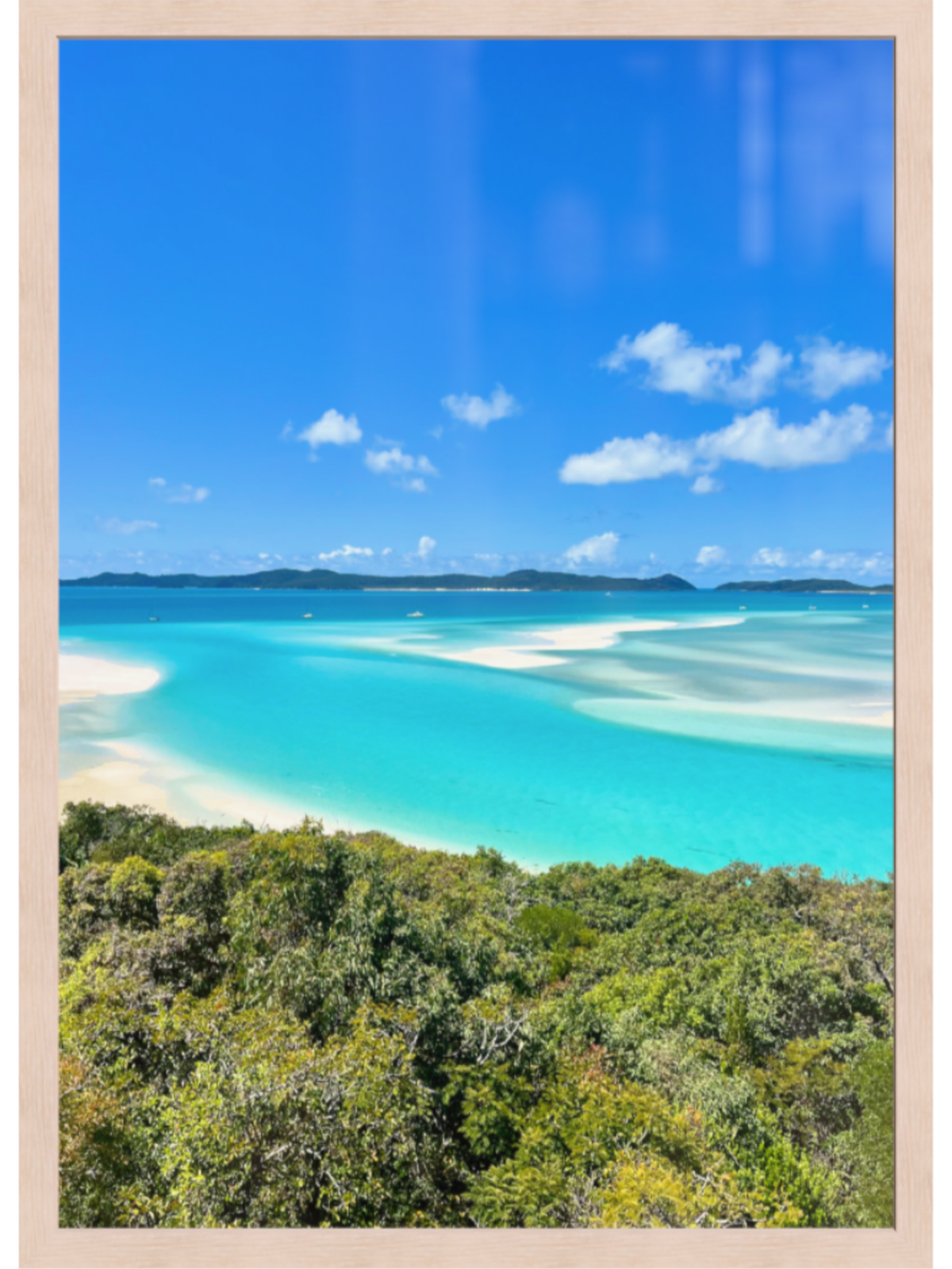 Scenic view of a tropical beach with clear blue water and white sand, framed as a poster.