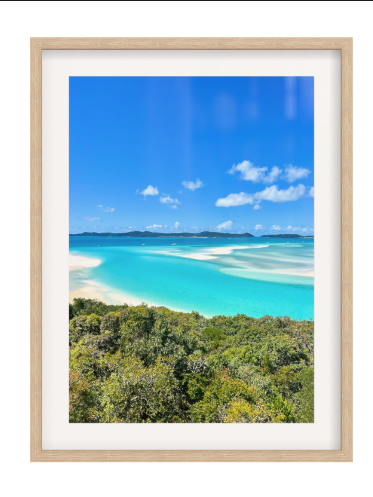 Framed photograph of a tropical beach with turquoise water and blue sky.