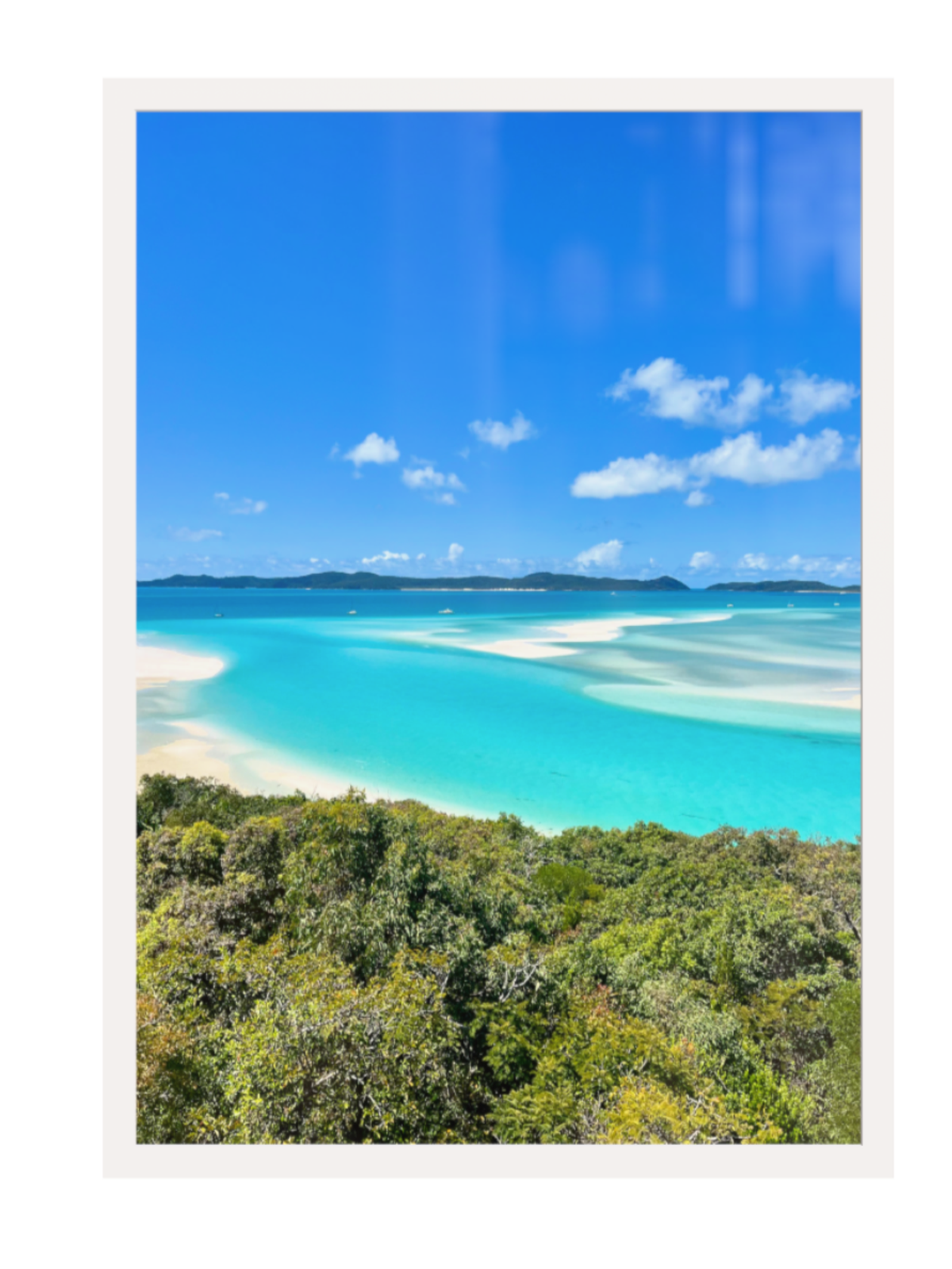 Tropical beach with turquoise water and white sand, framed by a white border.