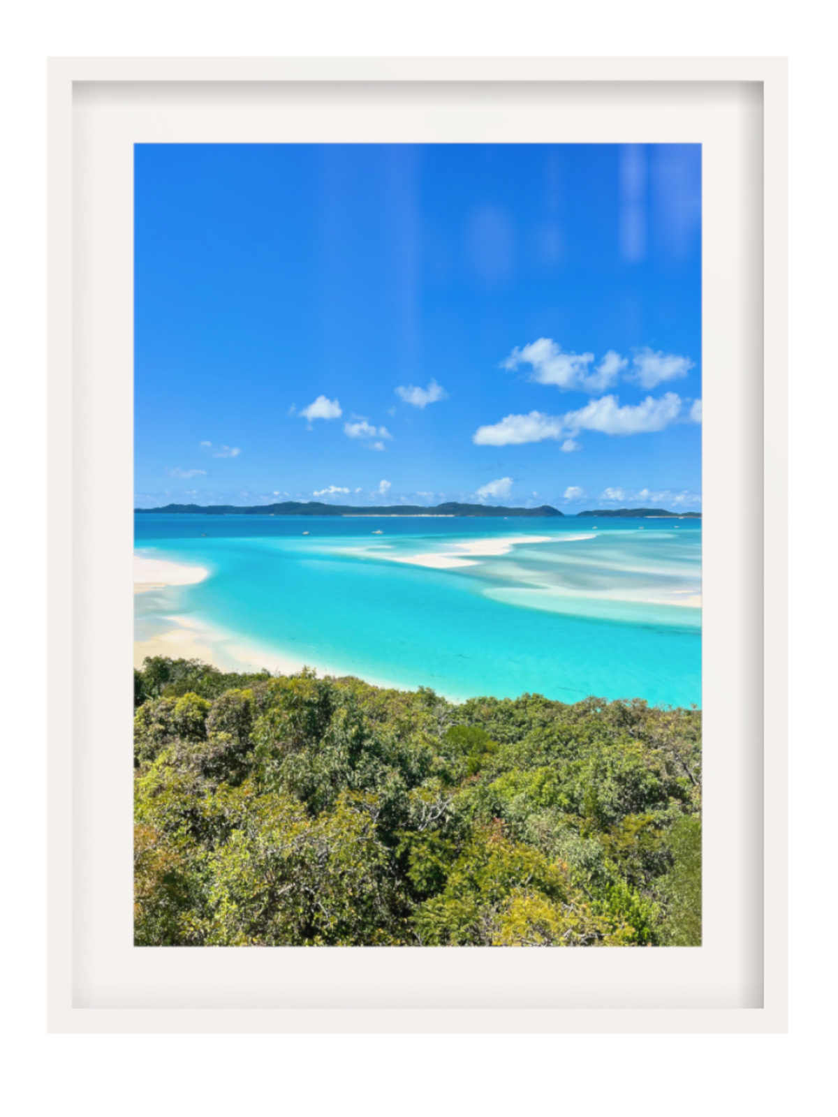 Framed photograph of a tropical beach with turquoise water and blue sky.