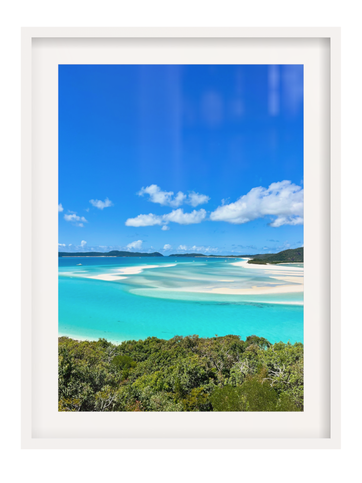 Framed photograph of a tropical beach with turquoise water and blue sky.