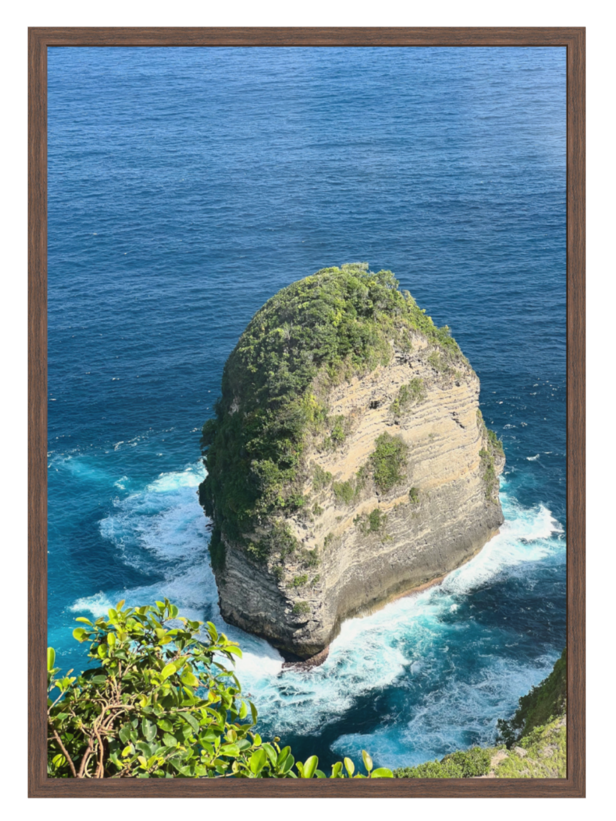 Chocolate Frame Isolated rock formation in the middle of the ocean with a wooden frame.