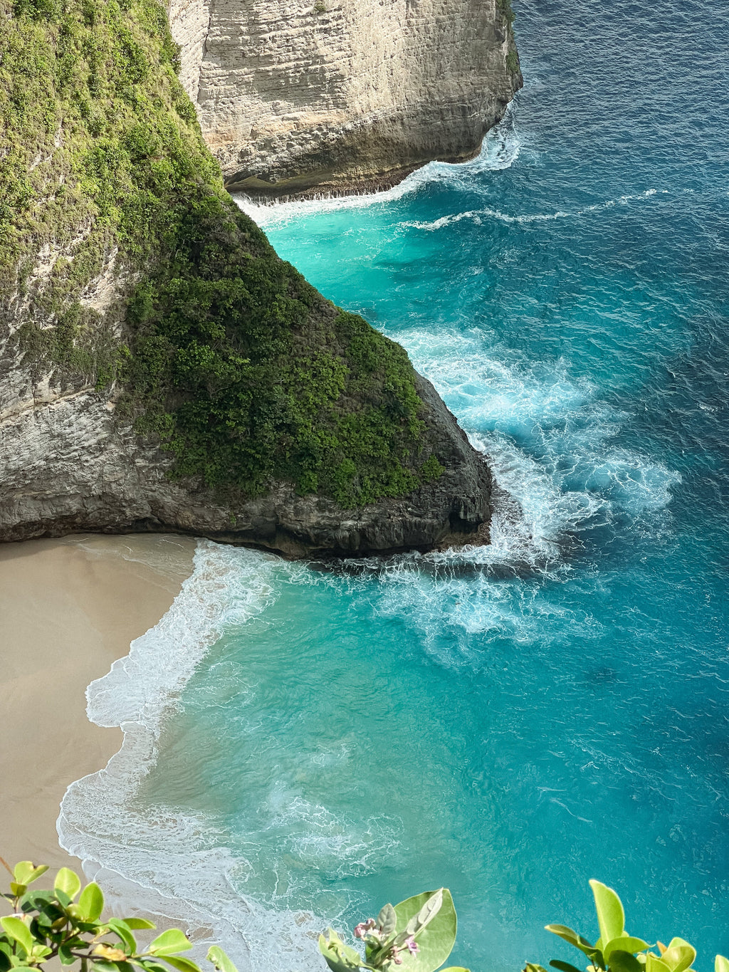 Tropical beach with turquoise water and rocky cliffs