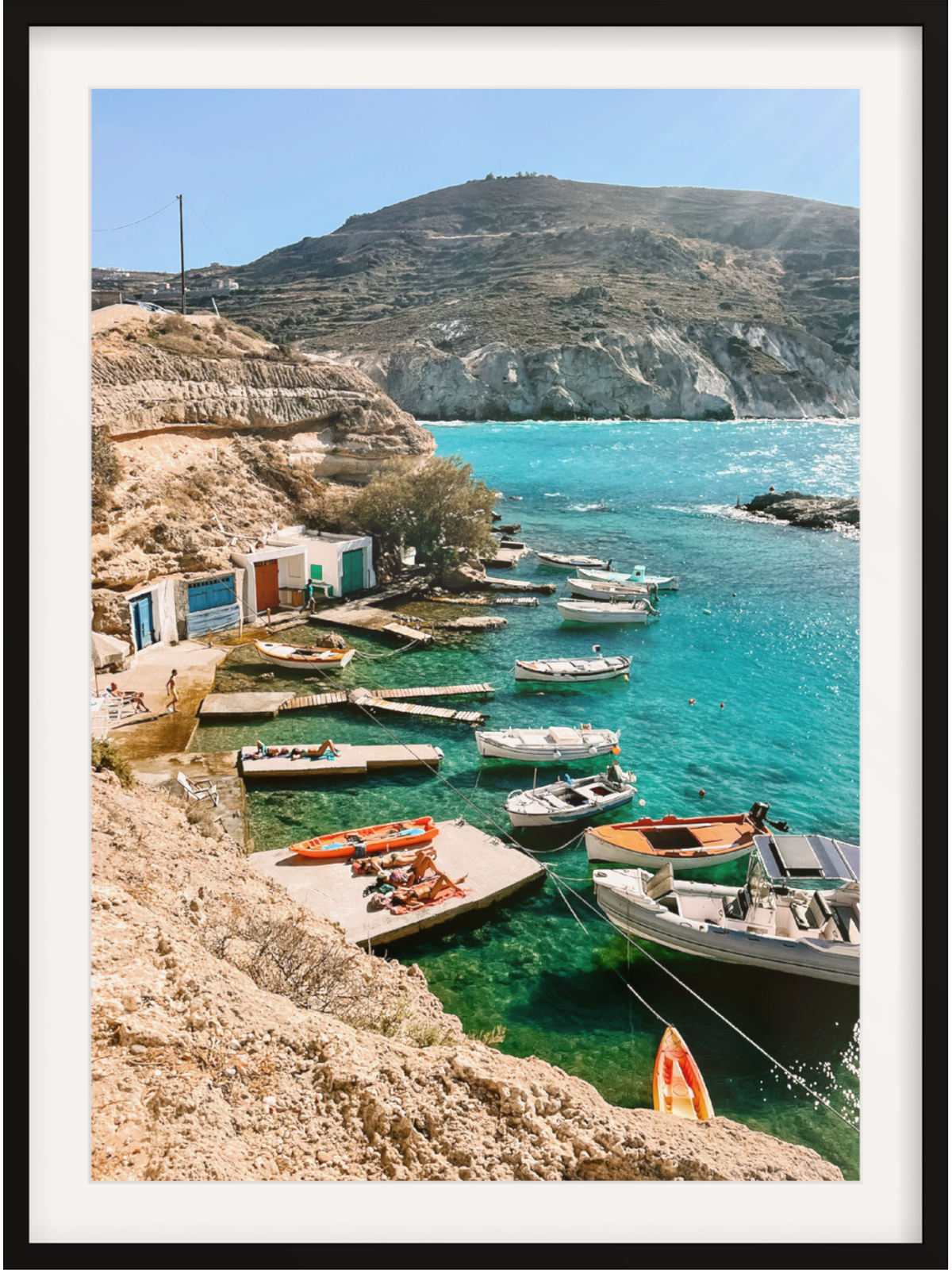 Coastal scene with boats docked in clear blue water, framed picture
