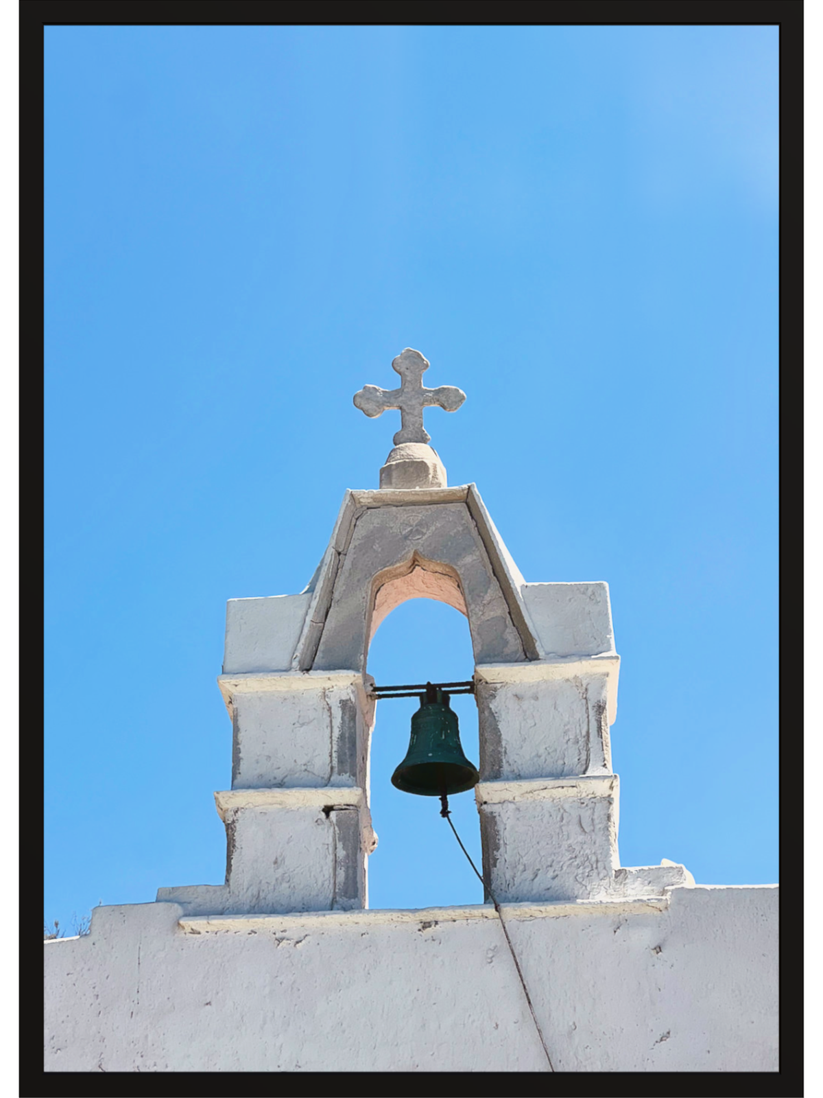 White stucco bell tower print against blue sky in black frame