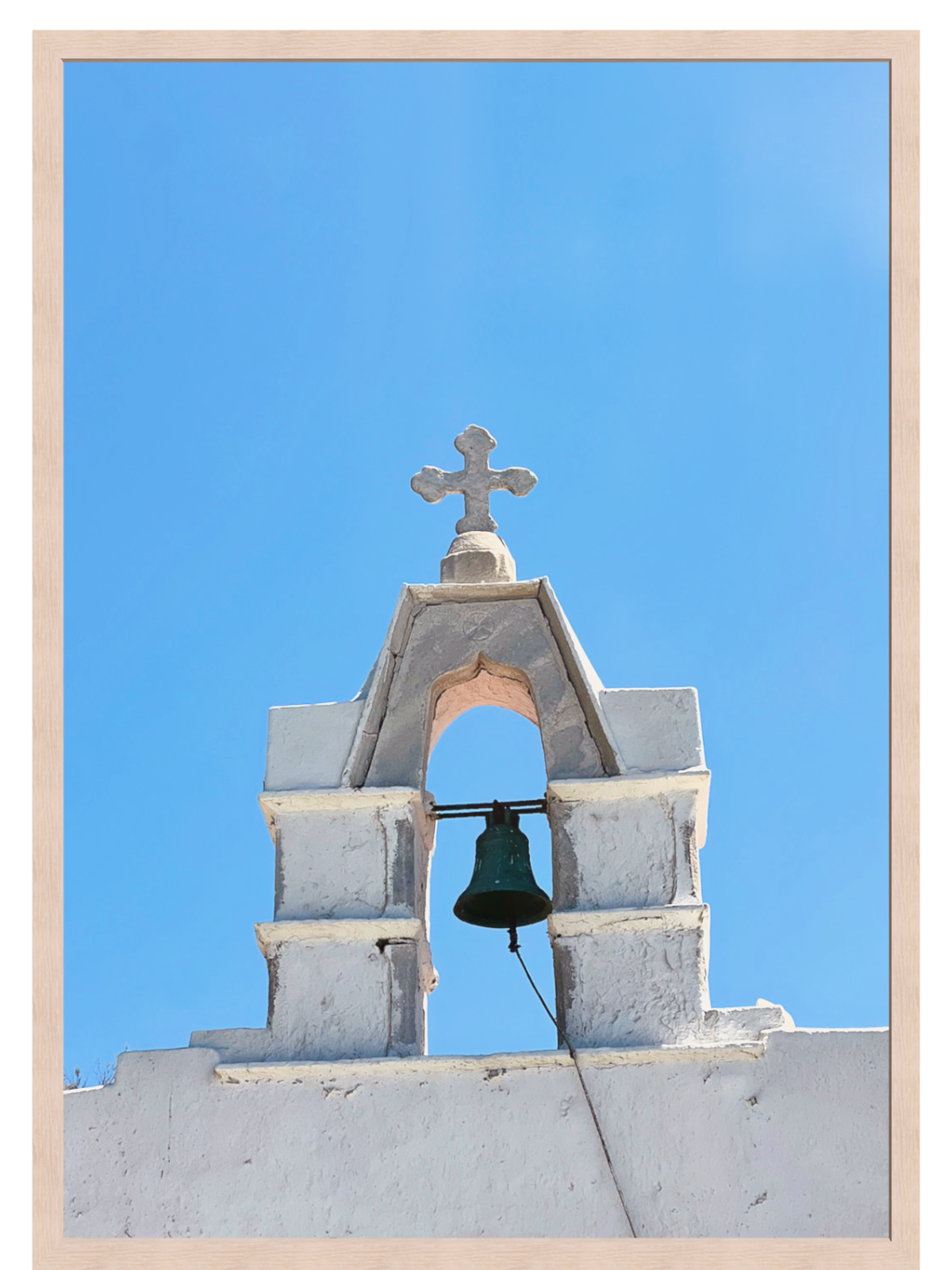 Low angle view of Mykonos archway and cross in thin mat