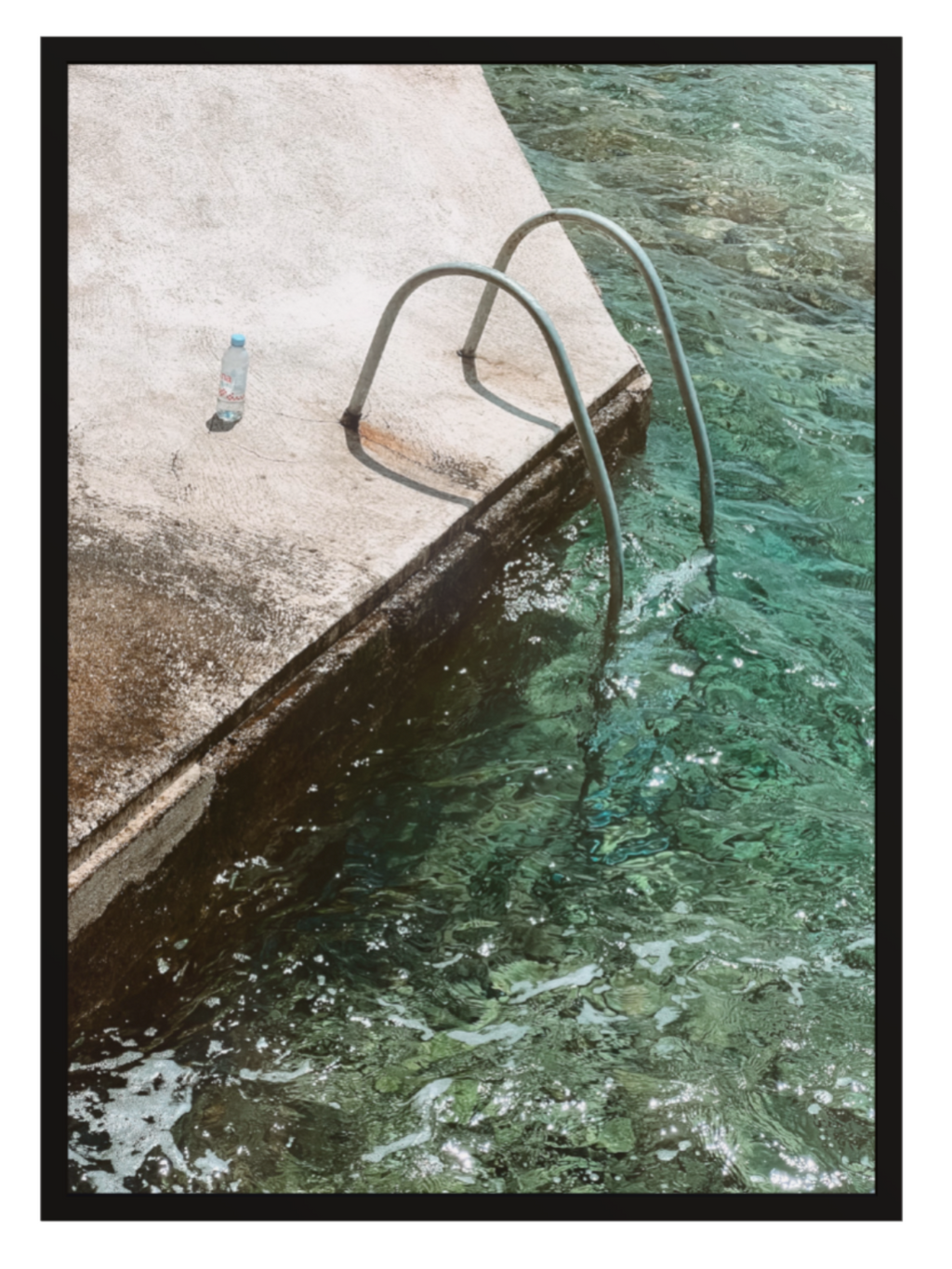 Ladder in a pool with water splashing around