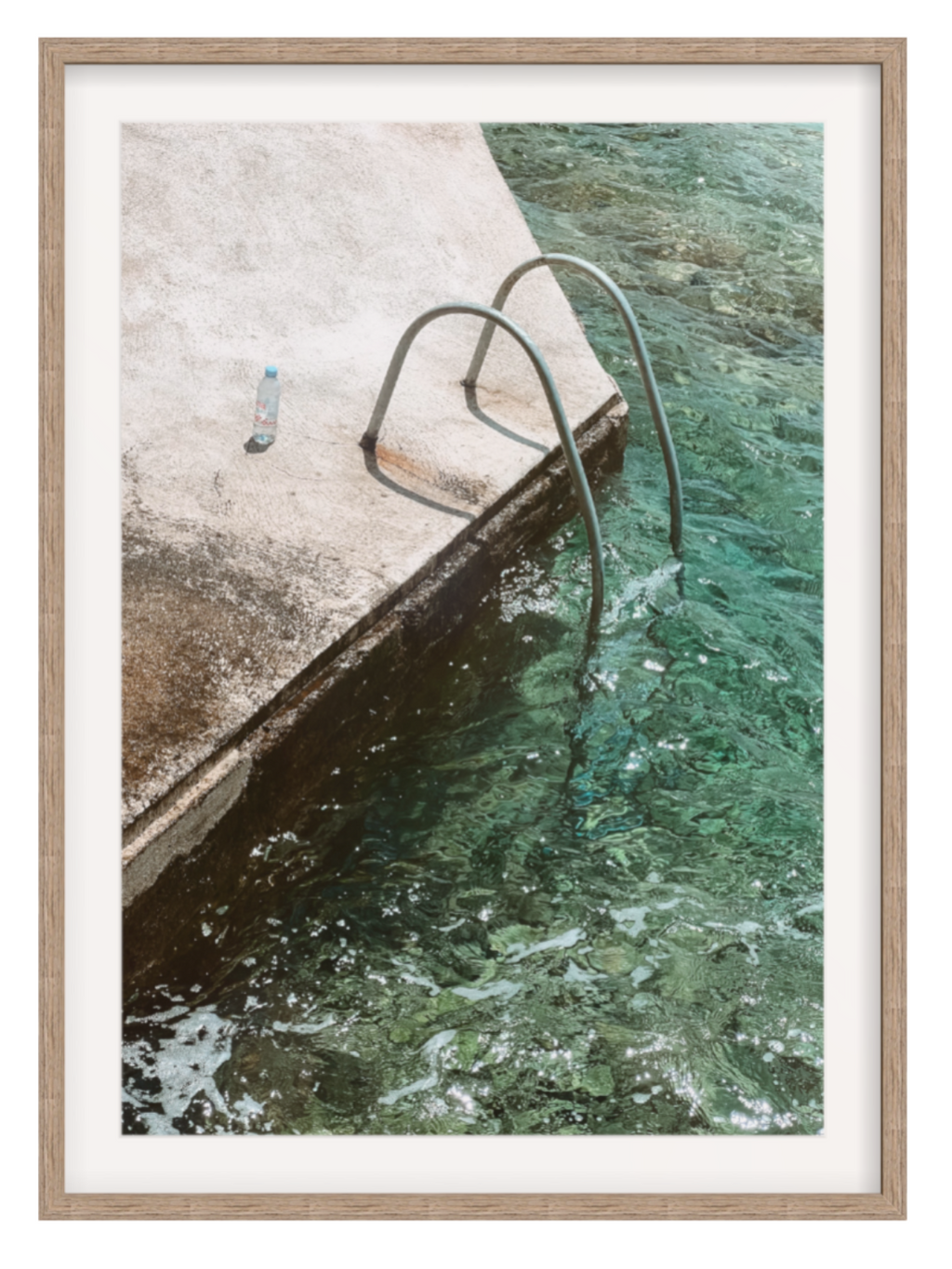 Framed photograph of a pool with a person standing on the edge.