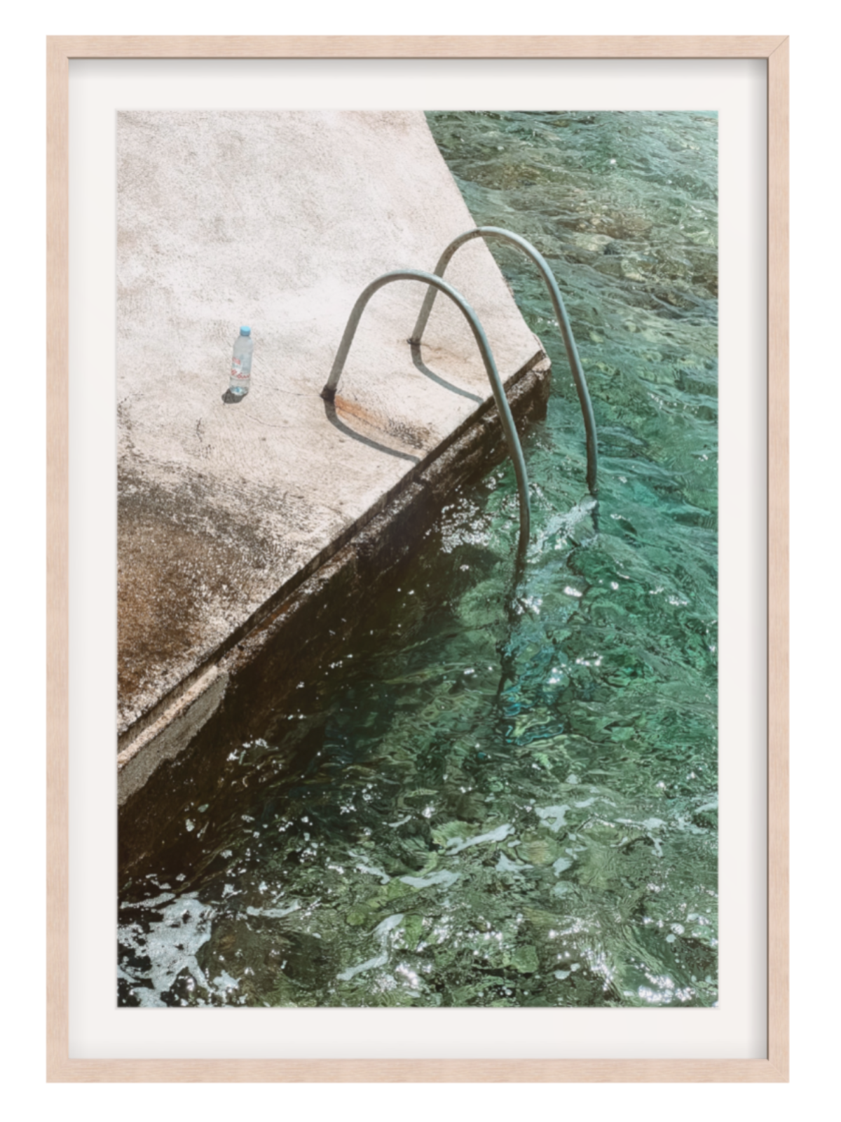 Framed photograph of a pool with a metal ladder and clear water.