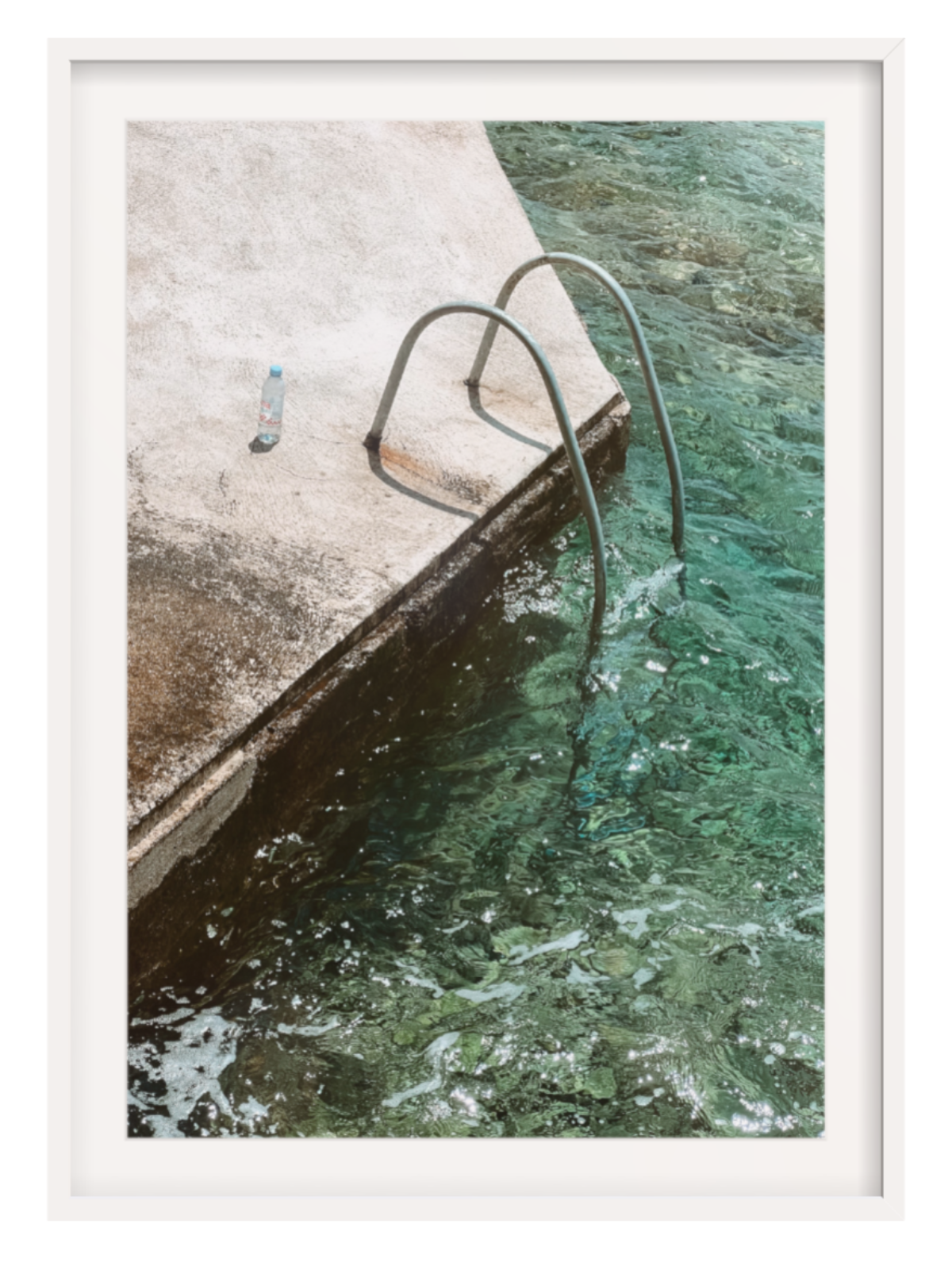 Person standing on a dock by a pool with a white frame