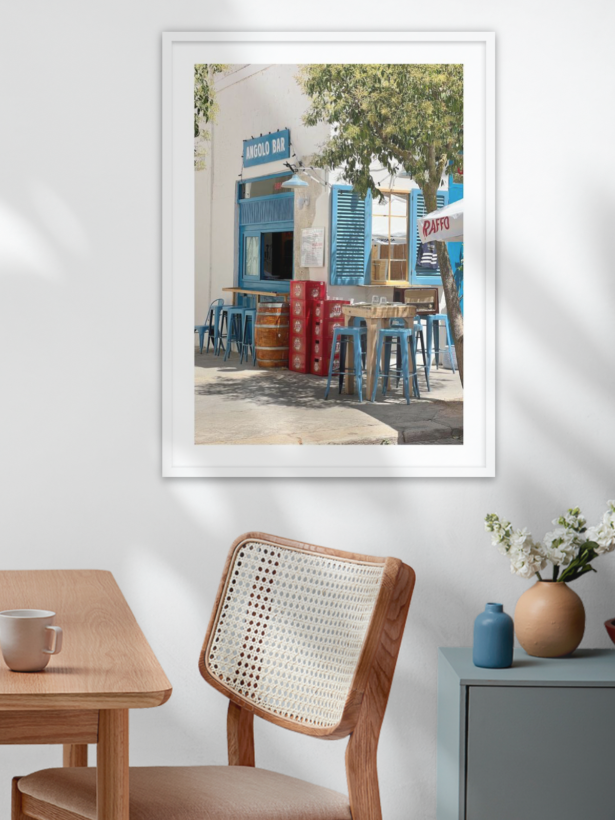 White frame hanging above wooden table strong contrast Mediterranean bar