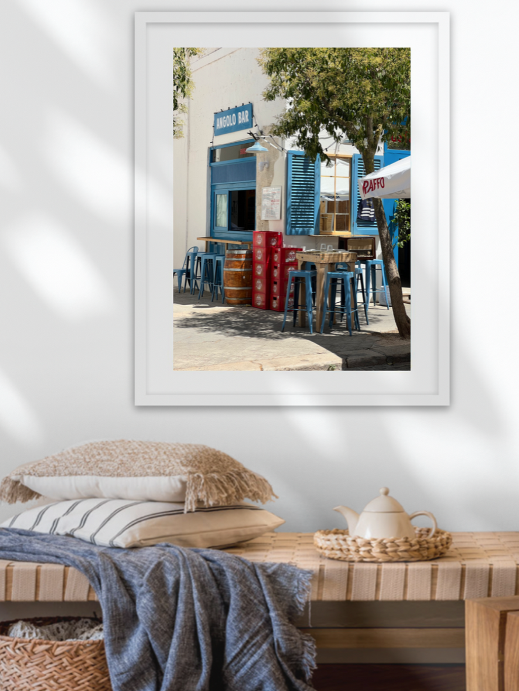 White frame wall mounted above woven bench Mediterranean home decor