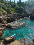 Paleokastritsa Greece coastal wall art print elevated view in light wood frame with volcanic rocks