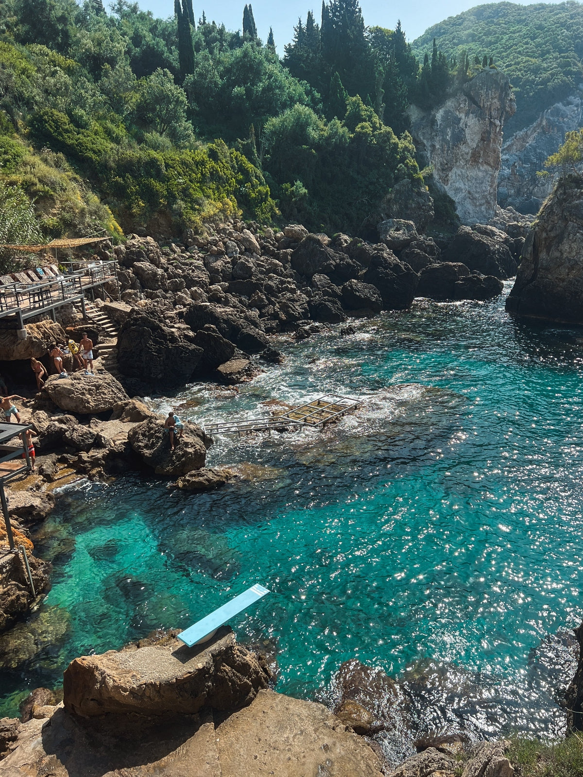 Paleokastritsa Greece coastal wall art print elevated view in light wood frame with volcanic rocks