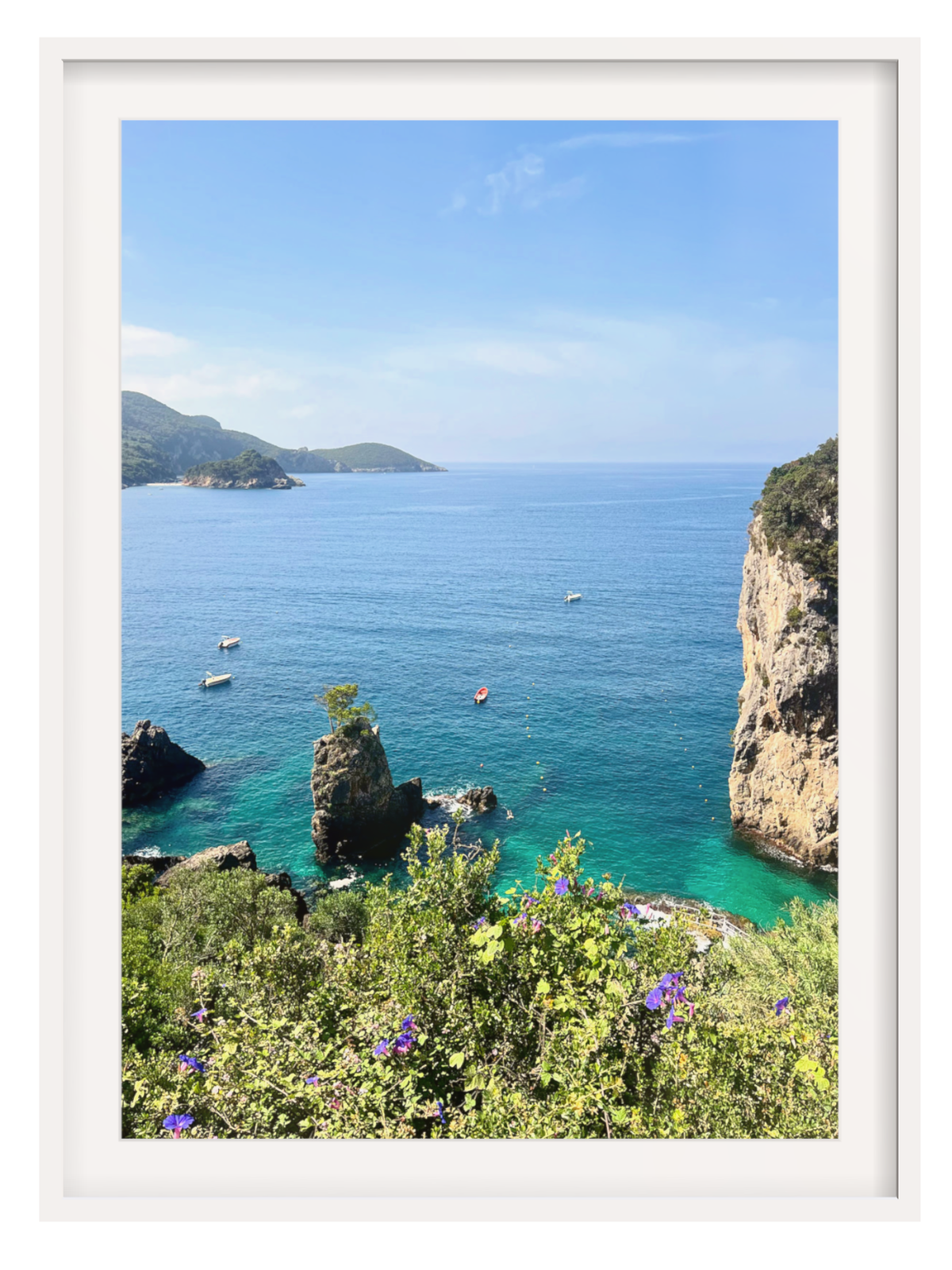 Scenic view of a coastal landscape with clear blue water and rocky cliffs.