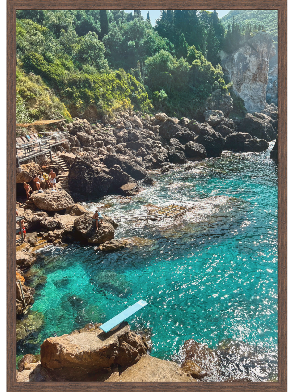 Paleokastritsa Greece coastal wall art print in dark wood frame featuring sunlit turquoise cove