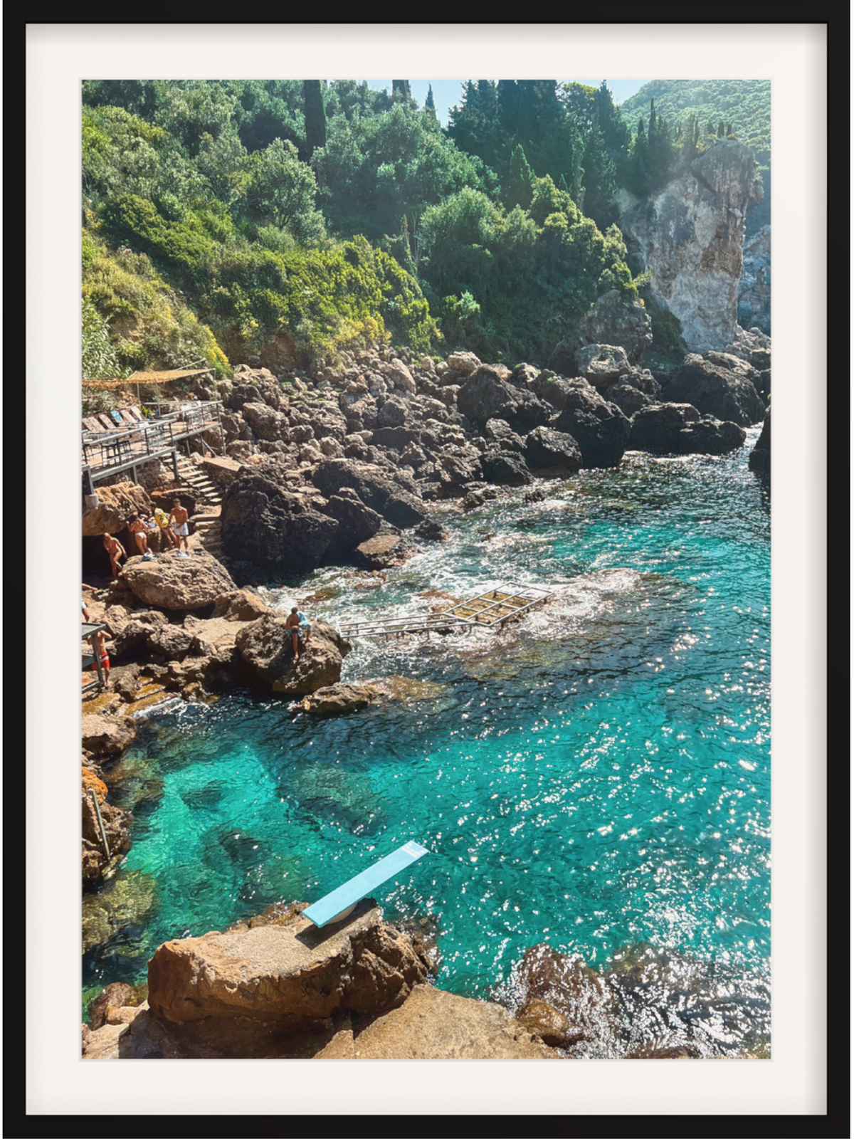 Paleokastritsa Greece coastal wall art print in black frame with white mat showing diving board scene