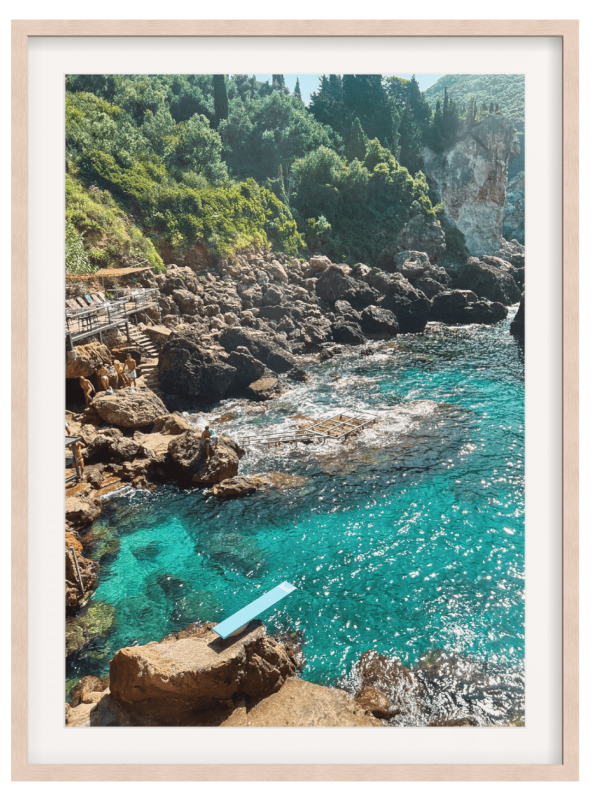 Paleokastritsa Greece coastal wall art print in light wood frame with people on wooden deck
