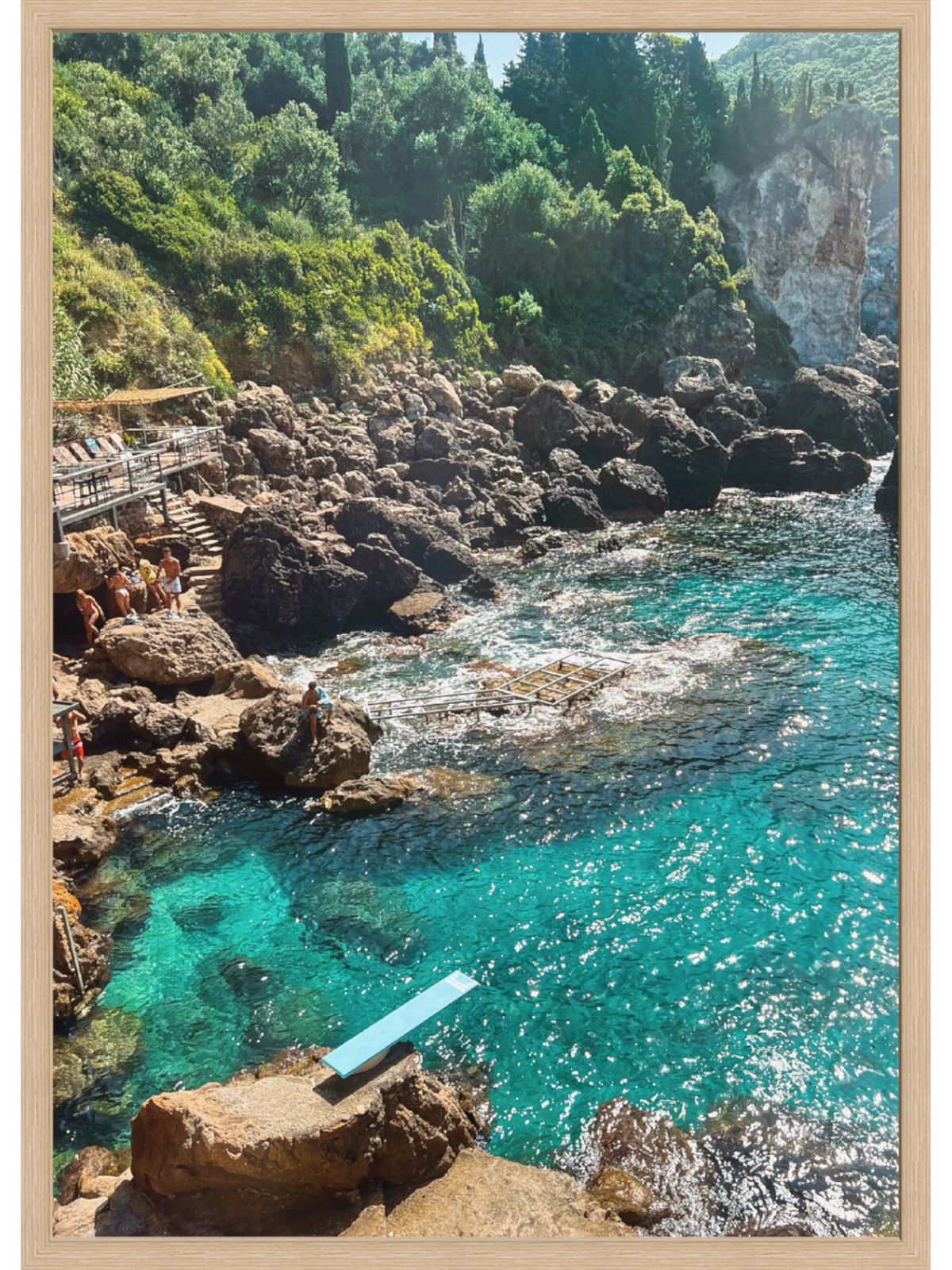 Paleokastritsa Greece coastal wall art print in light natural wood frame with sparkling water view
