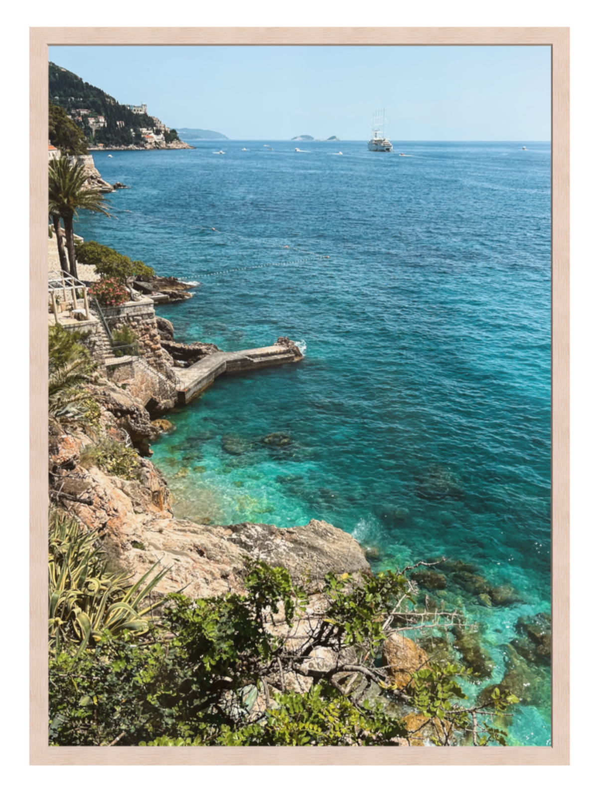 Coastal scene with turquoise waters and a rocky shoreline.