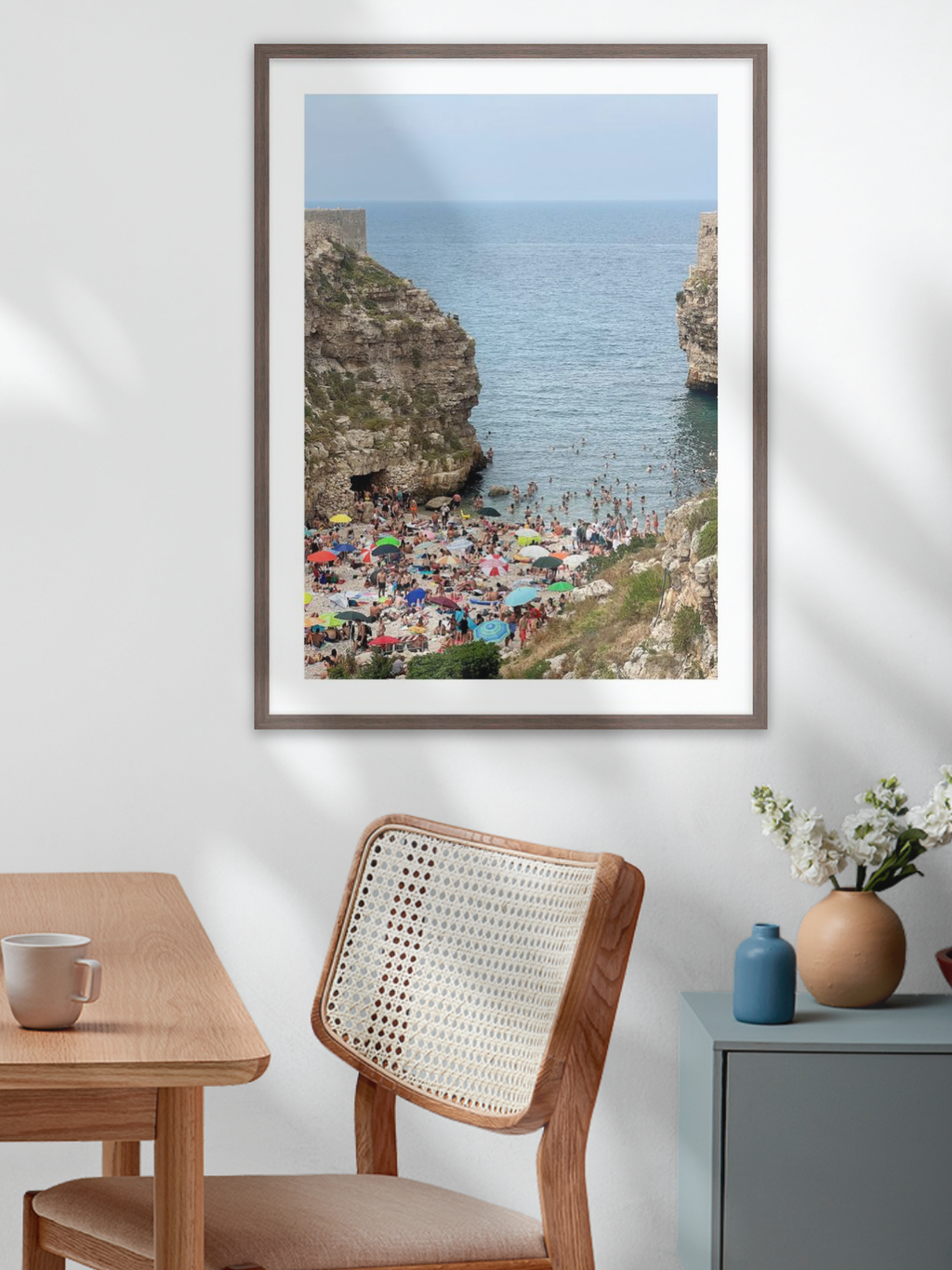 Polignano a Mare Italy wall art hanging above bed in dark wood frame