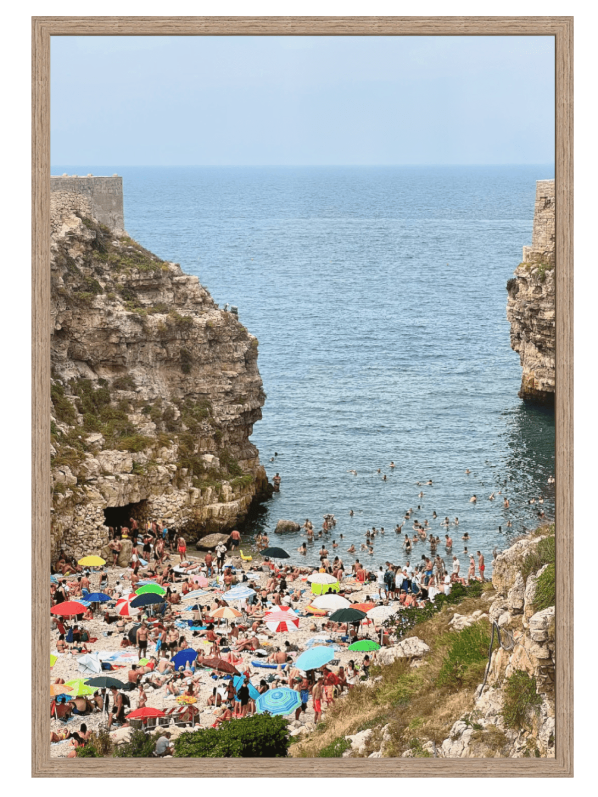 Polignano a Mare Italy sunlit cove wall art in light wood frame with mat