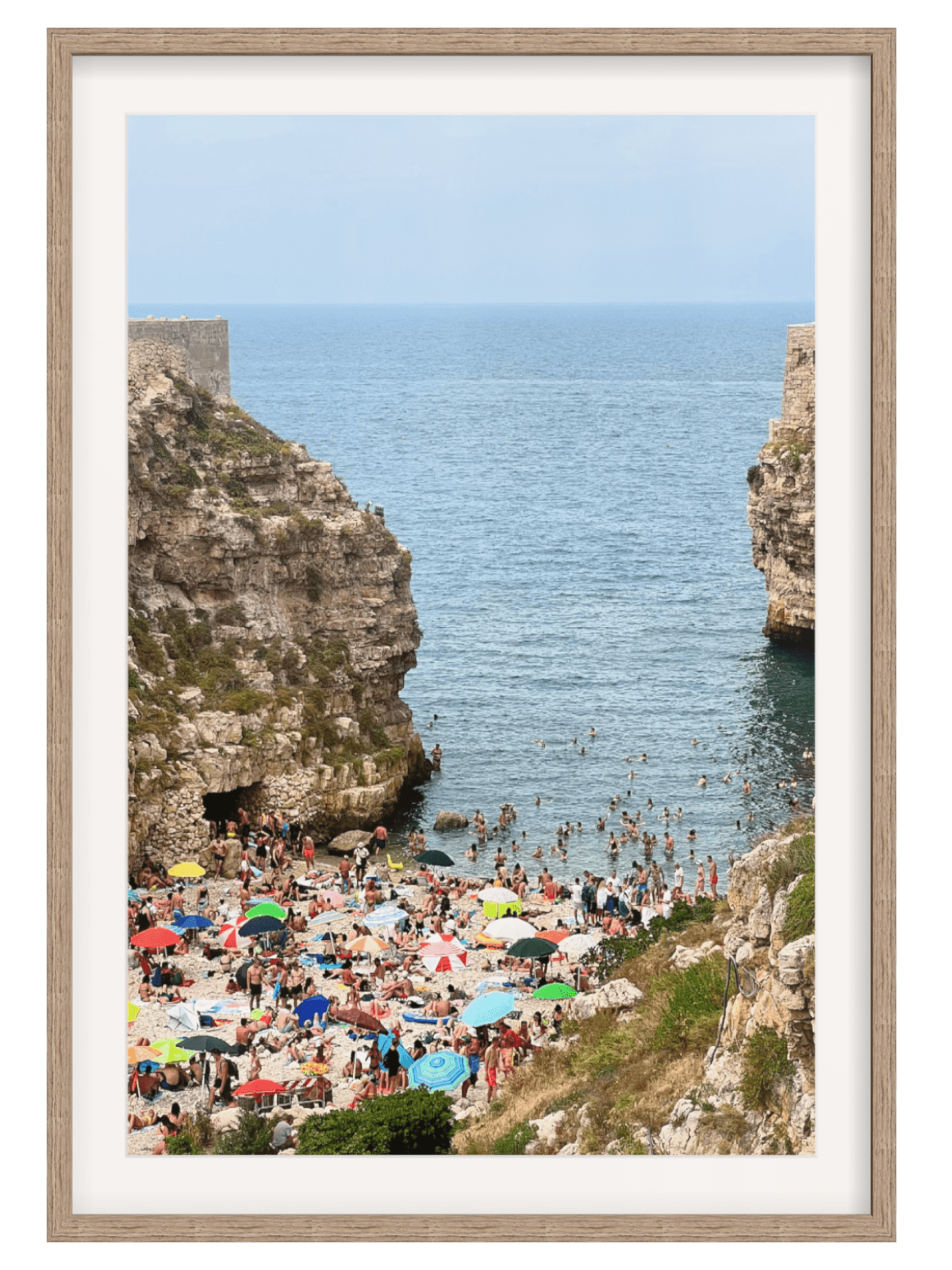 Polignano a Mare Italy pebble beach wall art print in light wood frame