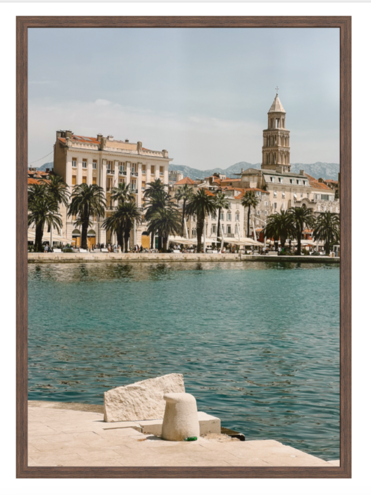 Cityscape with waterfront and historic tower, framed as a photograph. Split chocolate frame 
