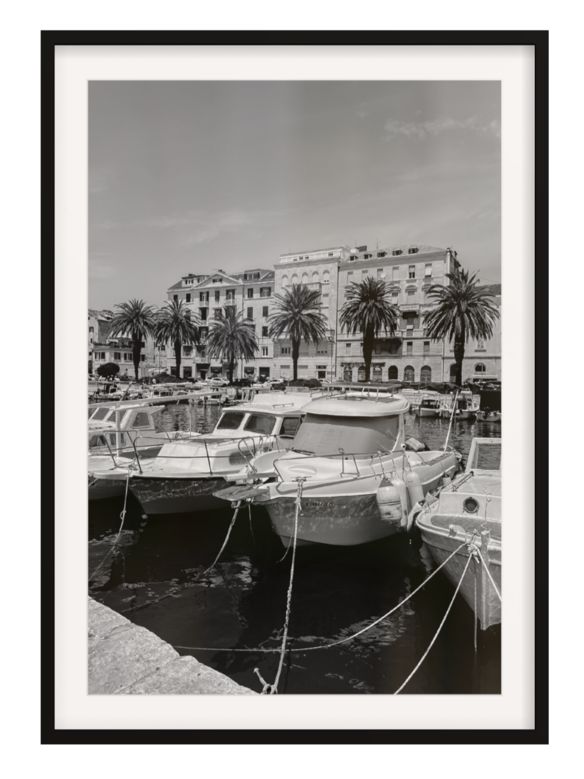 Harbor scene with boats and buildings, framed in black. Split harbour black frame with border