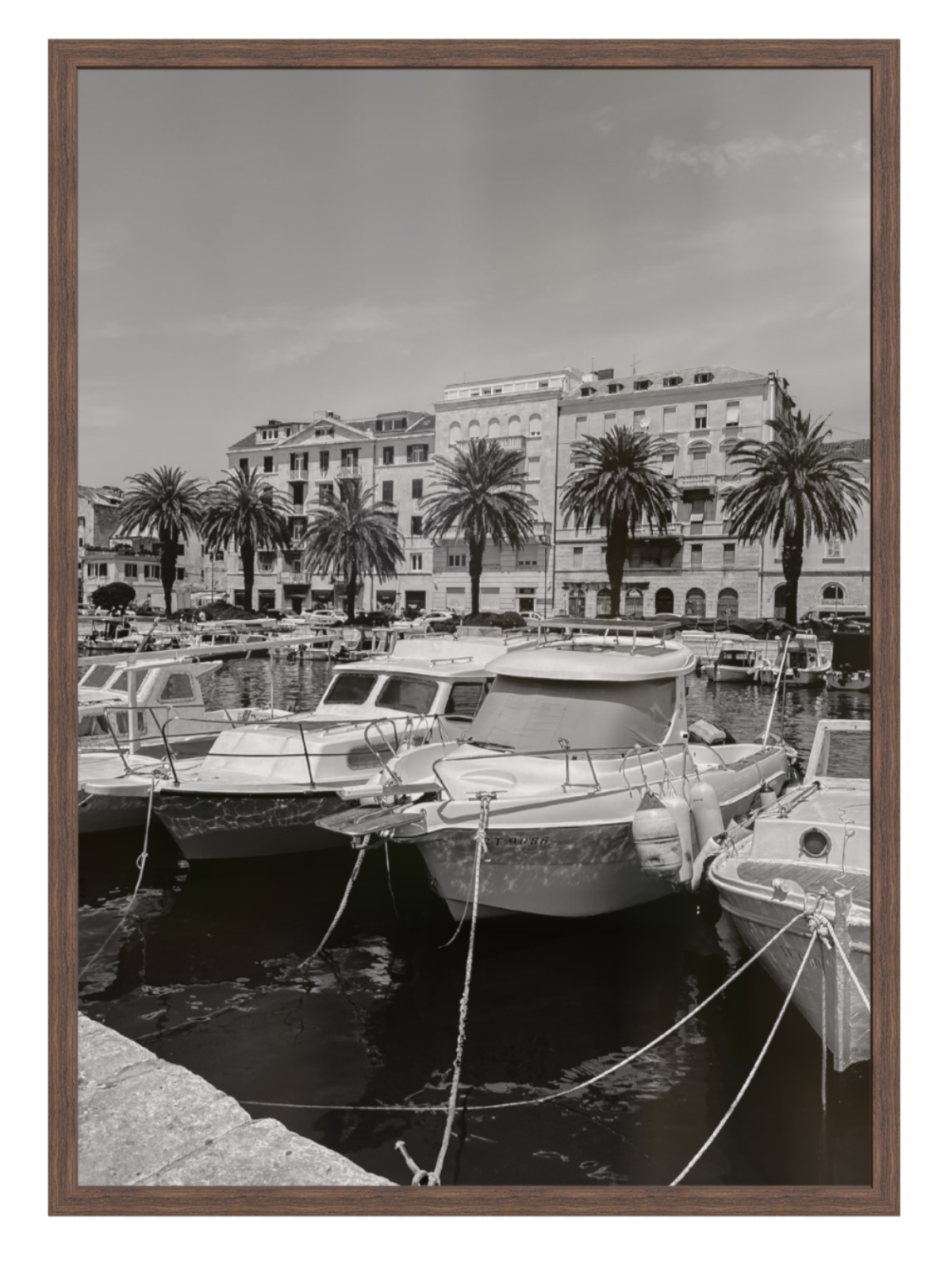 Harbor scene with boats and buildings, framed picture