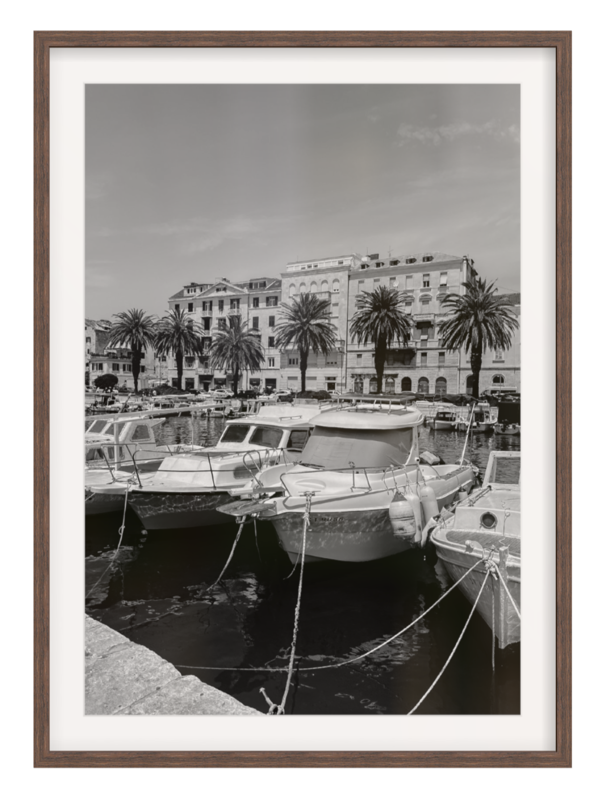 Harbor scene with boats and palm trees in a framed setting. Split harbour chocolate frame with border
