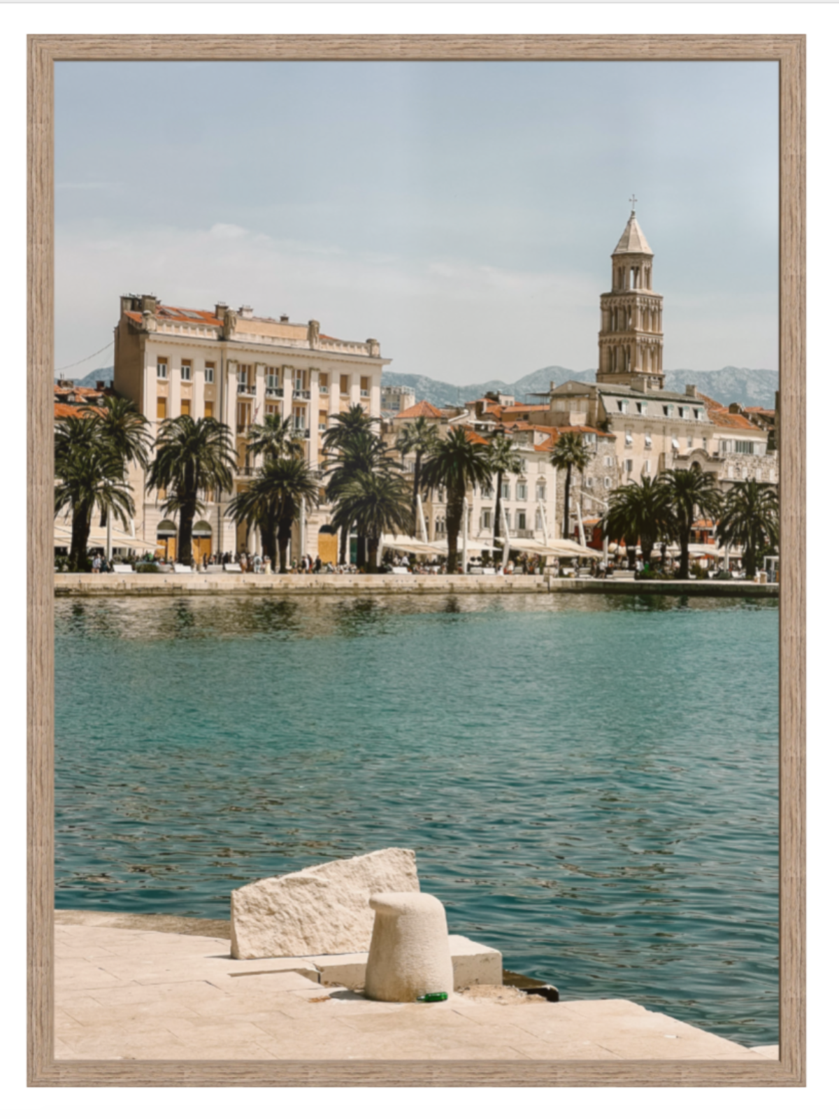 Framed photograph of a coastal cityscape with a clock tower and waterfront. Split hazel frame 
