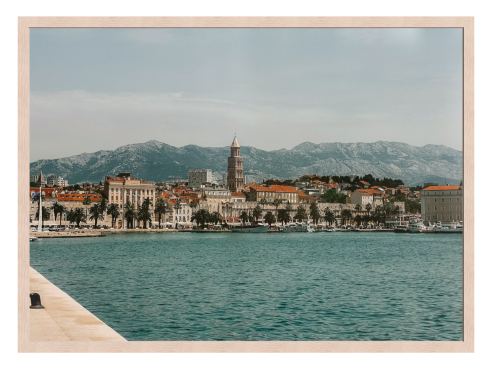 Cityscape with a coastal view and mountains in the background. Split landscape light oak frame 