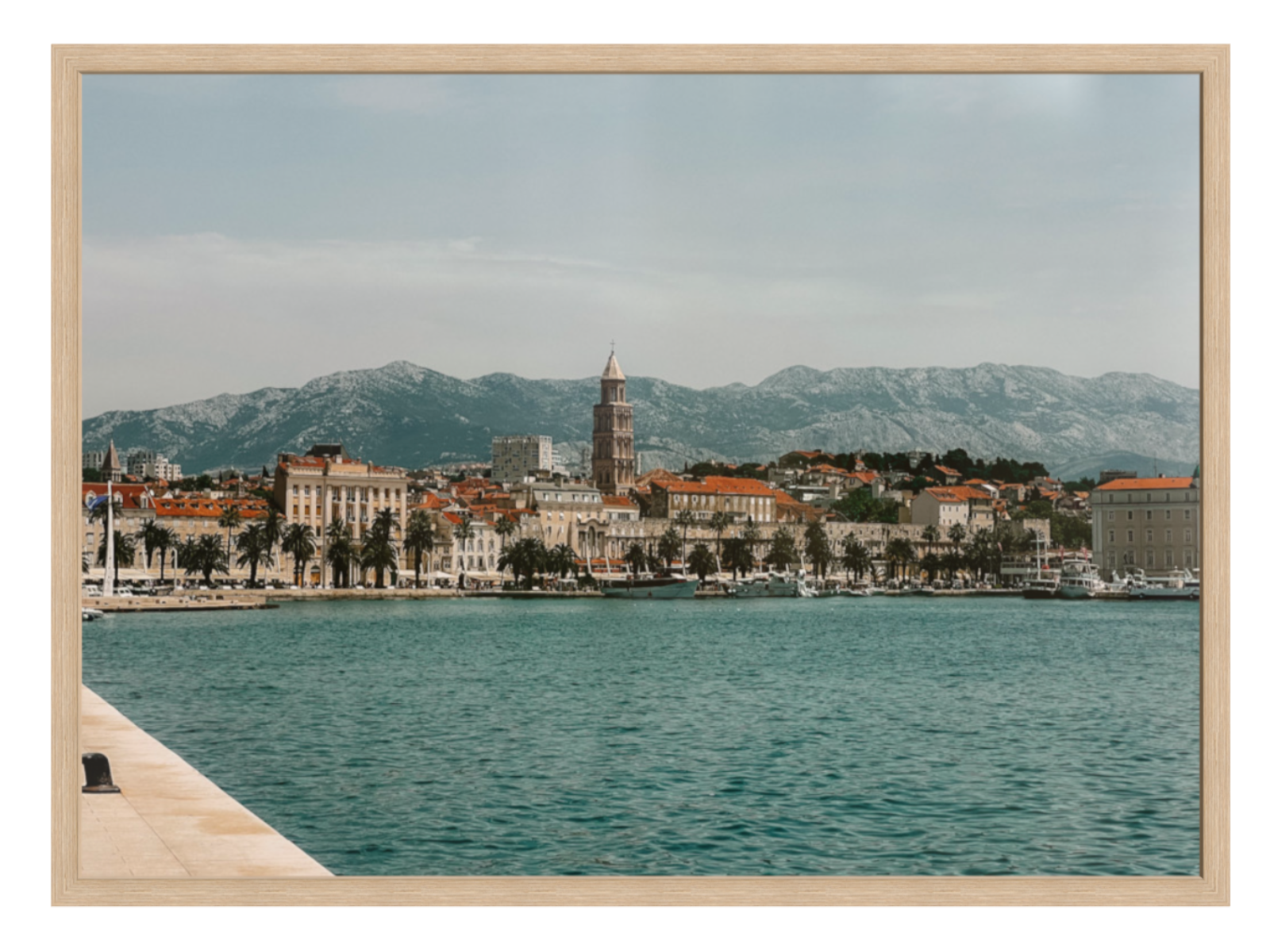 Cityscape with a clock tower by a body of water, framed as a photograph. Split landscape oak frame 