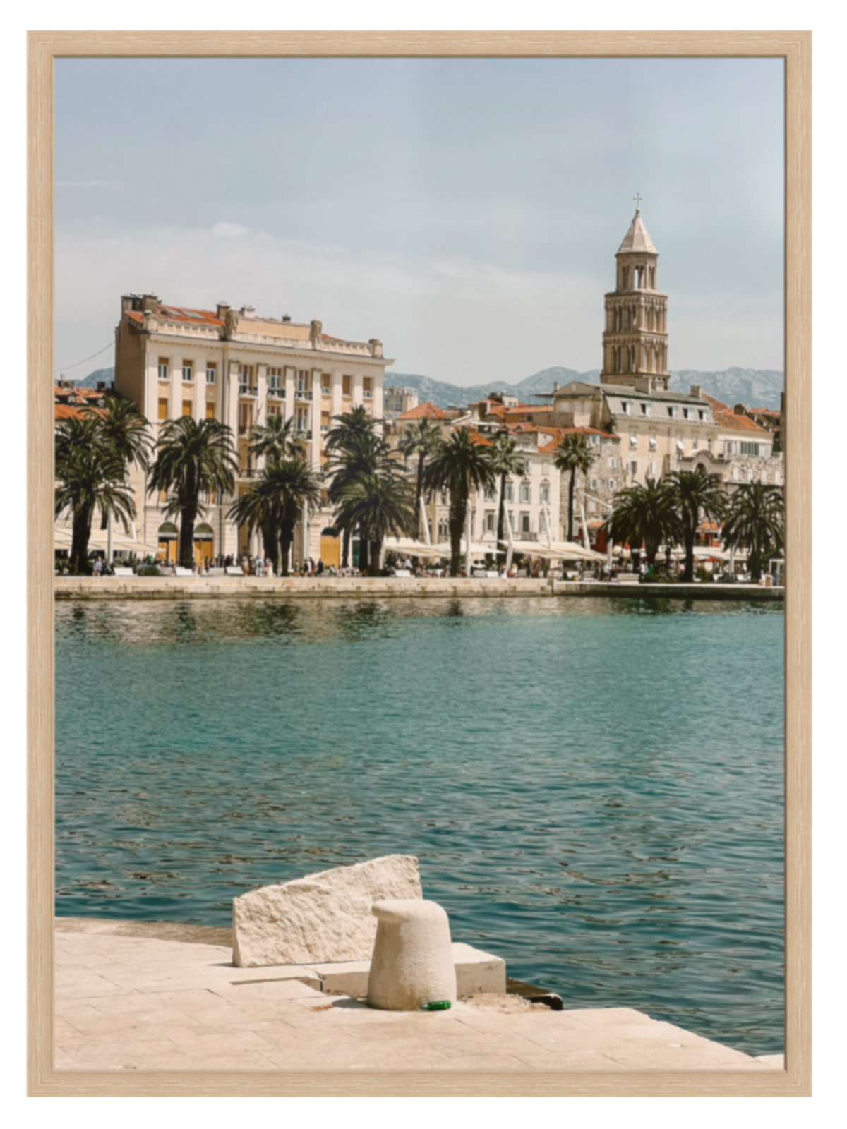 Cityscape with waterfront and historic buildings, framed as a print. Split oak frame 