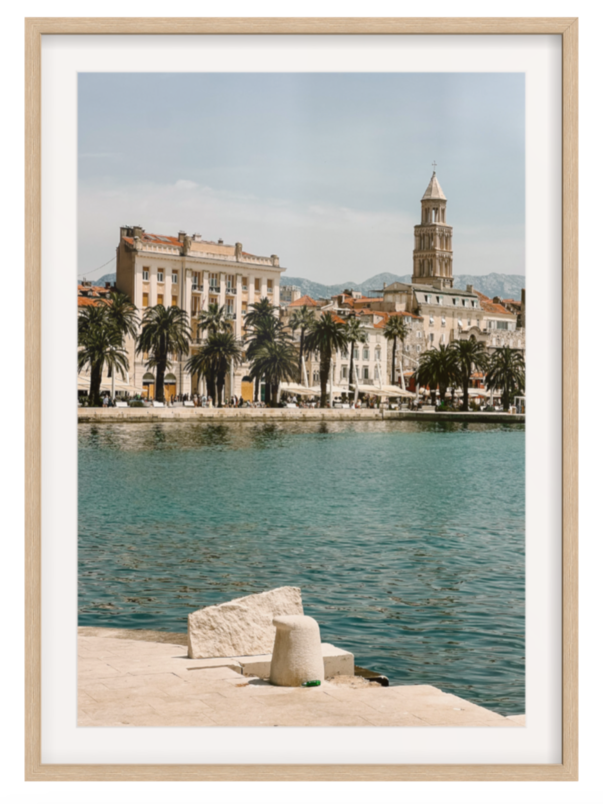 Framed photograph of a coastal cityscape with a clock tower and waterfront.