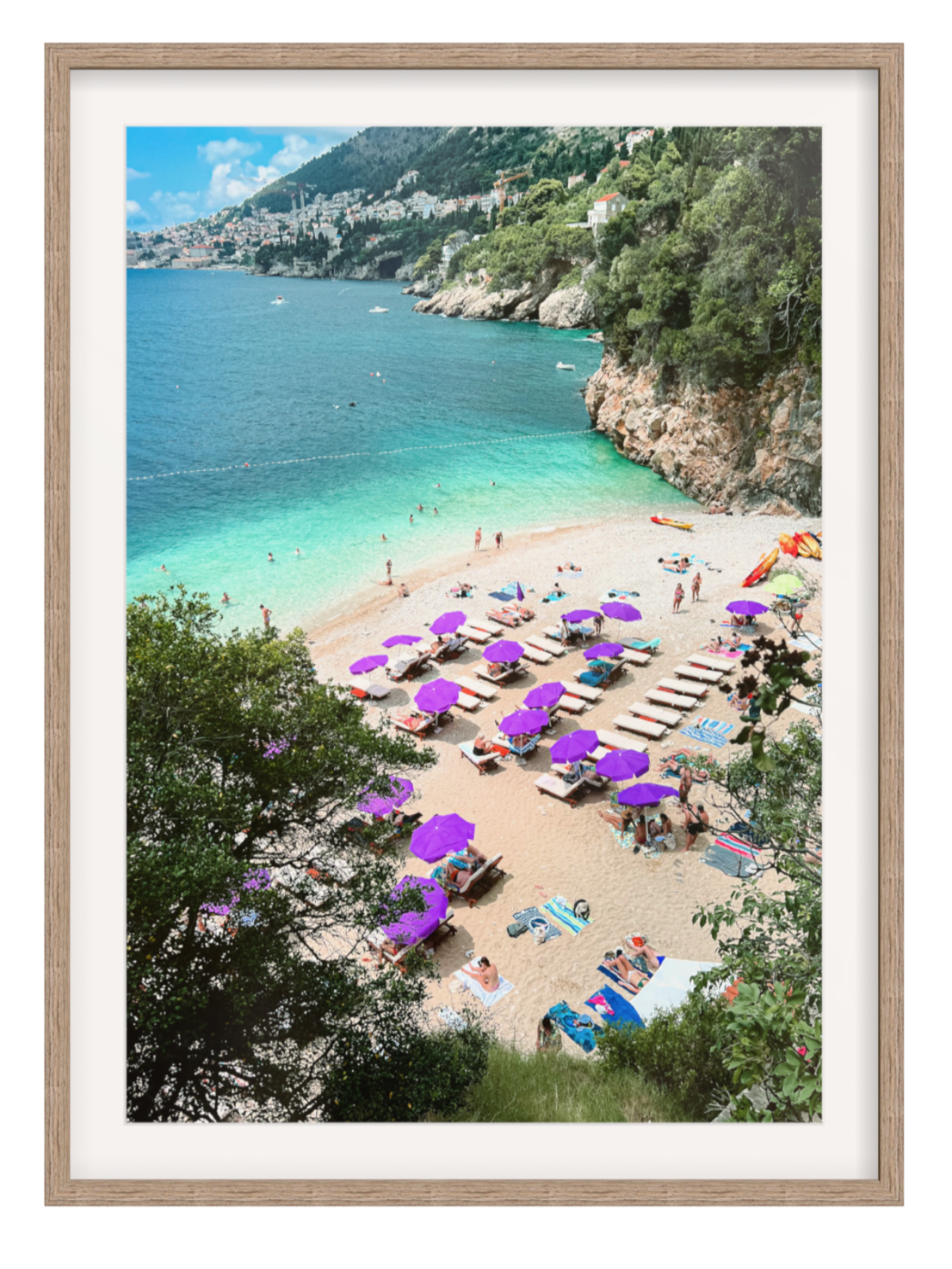 Beach scene with purple umbrellas and people, framed picture