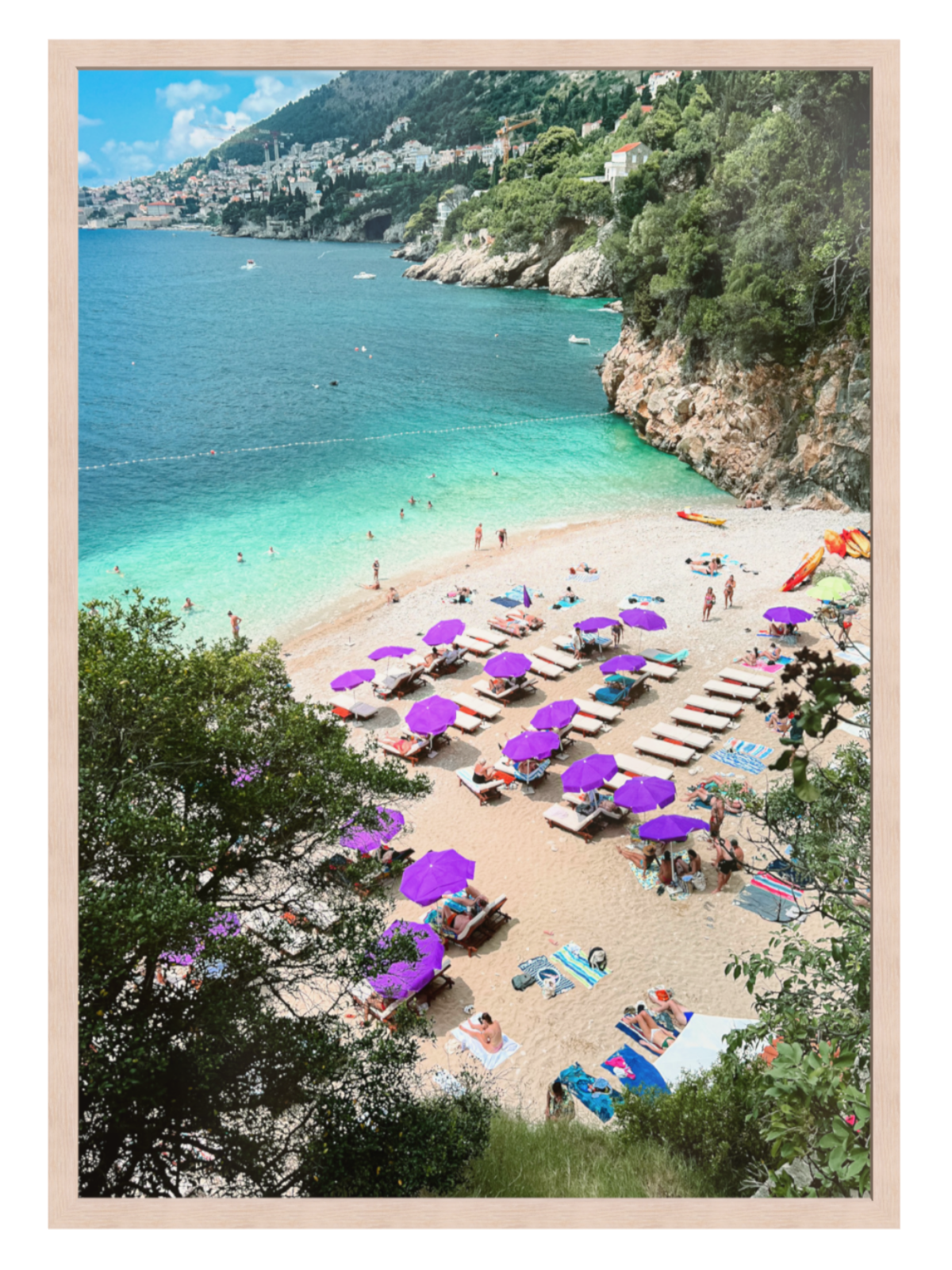 Beach scene with purple umbrellas and people enjoying the sun, framed picture.