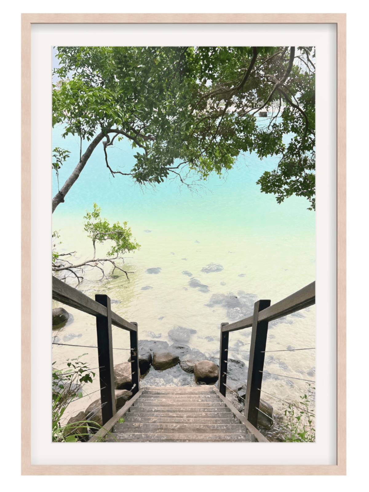 Framed artwork of a wooden staircase leading to a serene beach with trees.