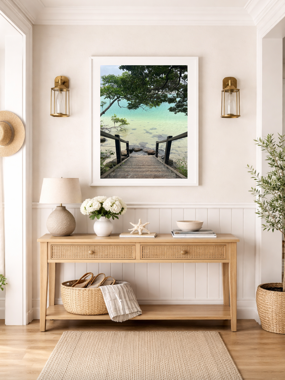 Nautical-themed room with a wooden console table, beach-themed artwork, and decorative items.