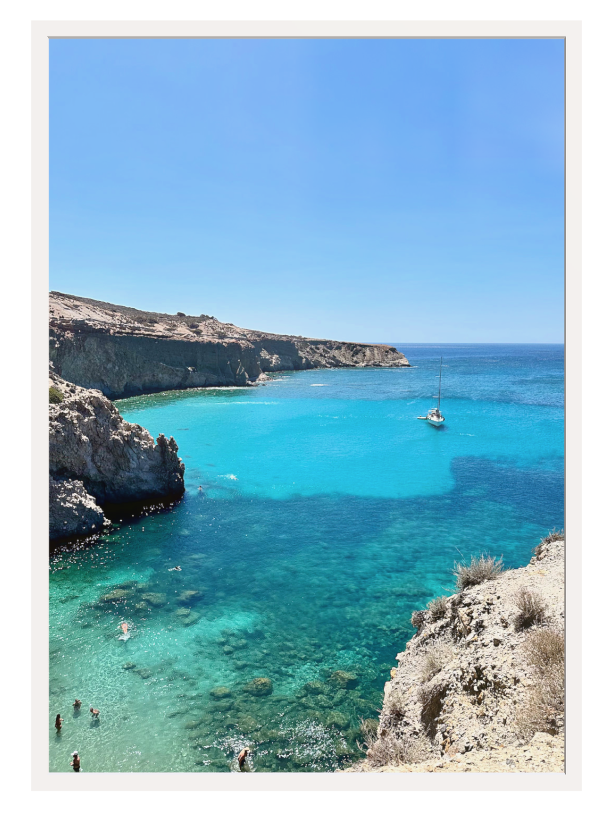 Turquoise sea with a small island and clear blue sky