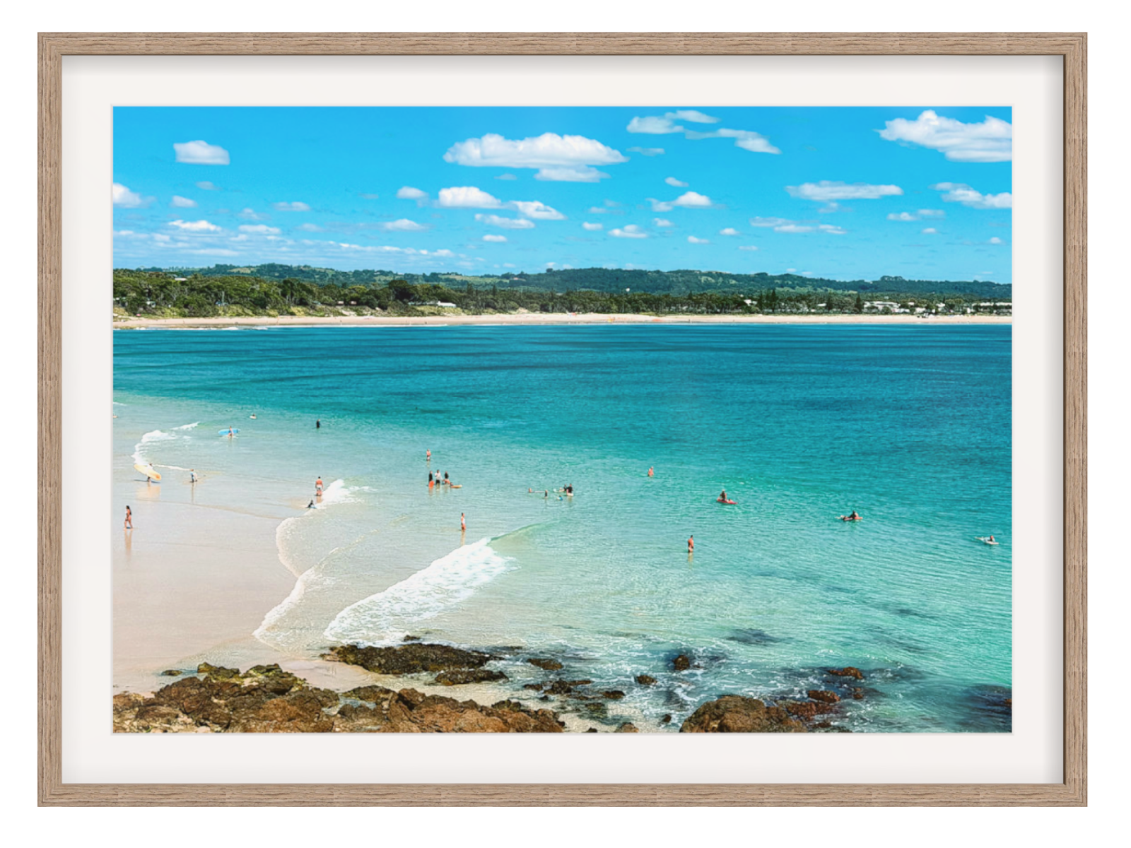 Framed artwork of a beach scene with clear blue water and white sand.