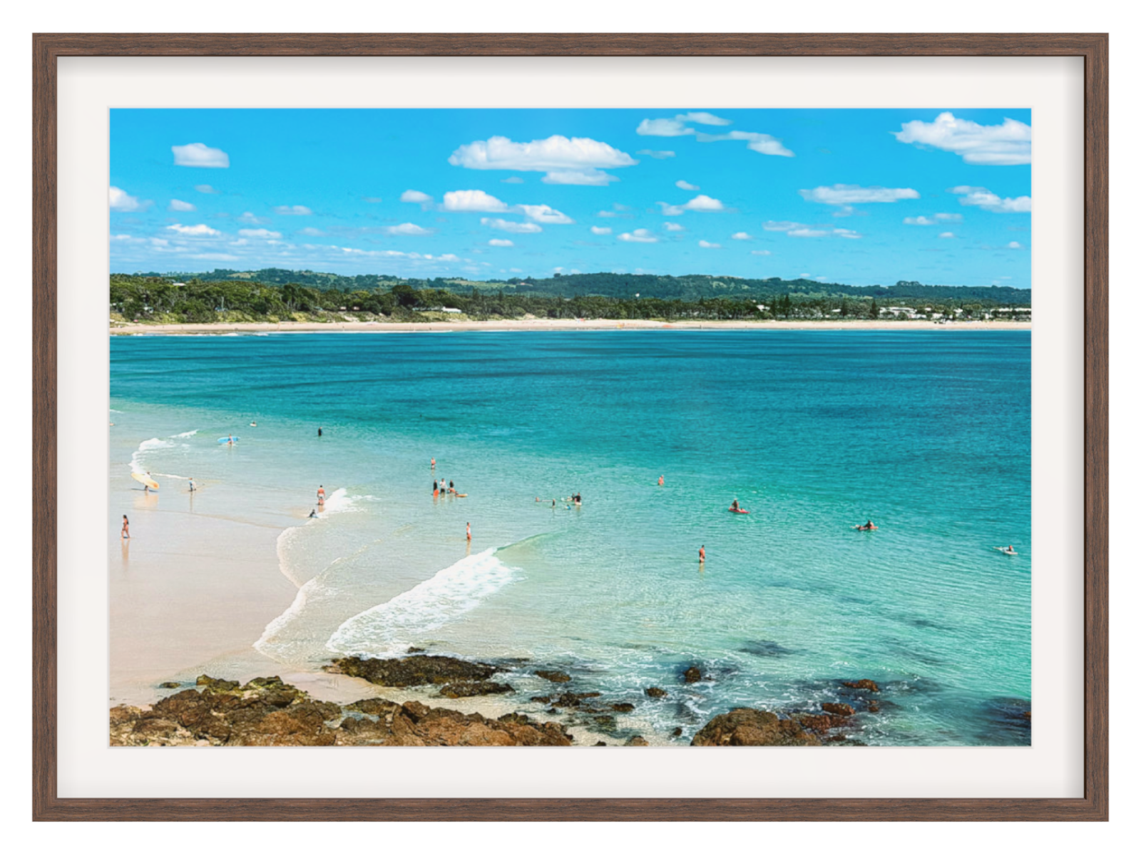 Framed artwork of a beach scene with clear blue water and white sand.