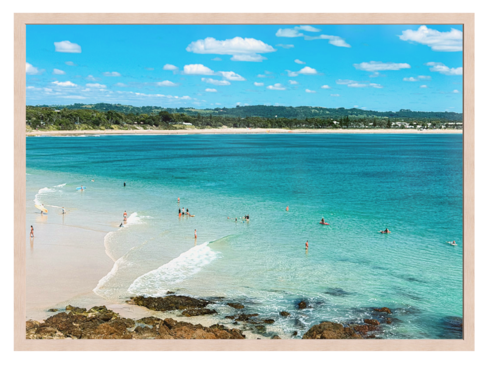 Beach scene with clear blue water and a sandy shore.