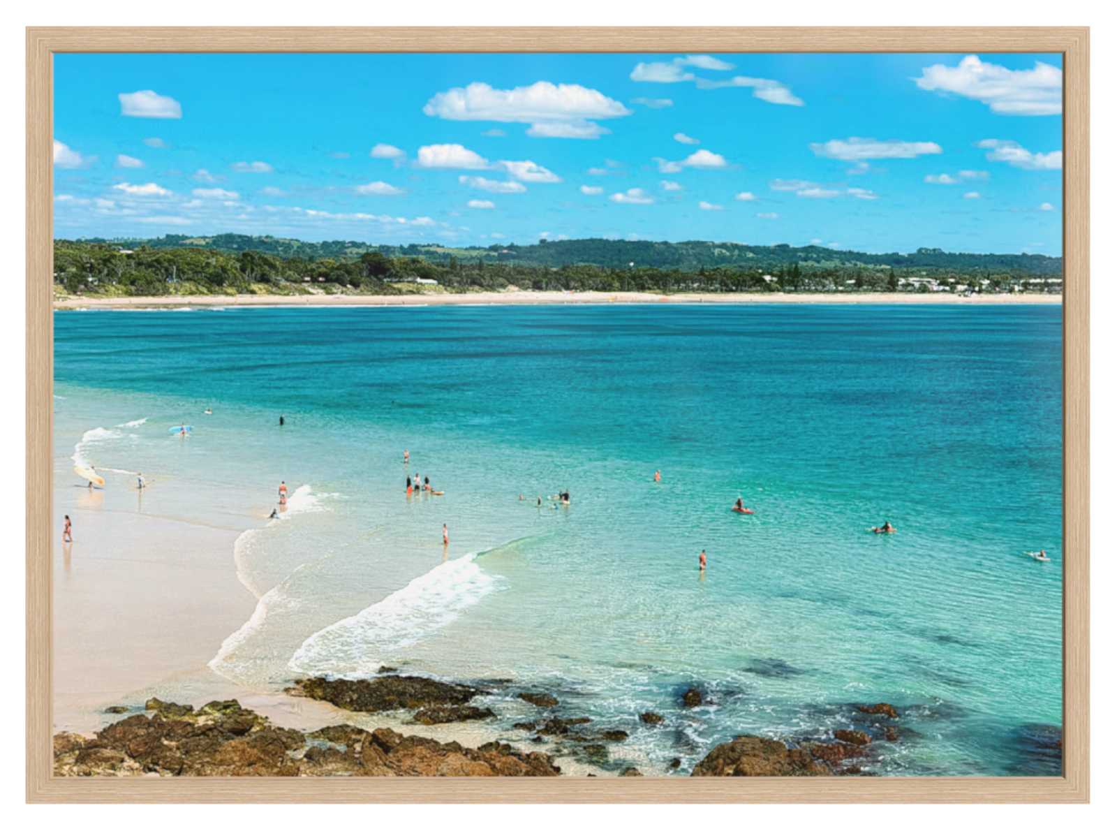 Beach scene with clear blue water and white sand, framed with a beige border.