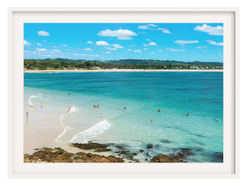 Framed photograph of a beach scene with clear blue water and white sand.