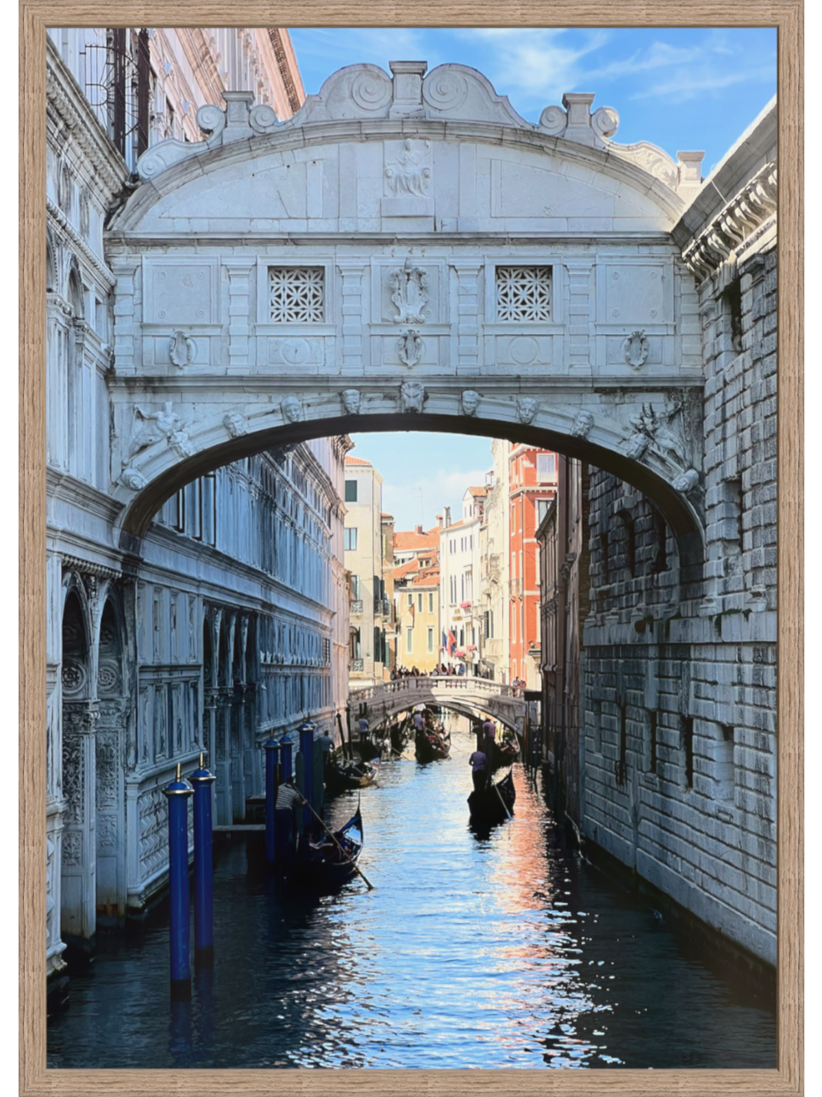 Light grain wood framed Venice canal art with red-tiled roofs