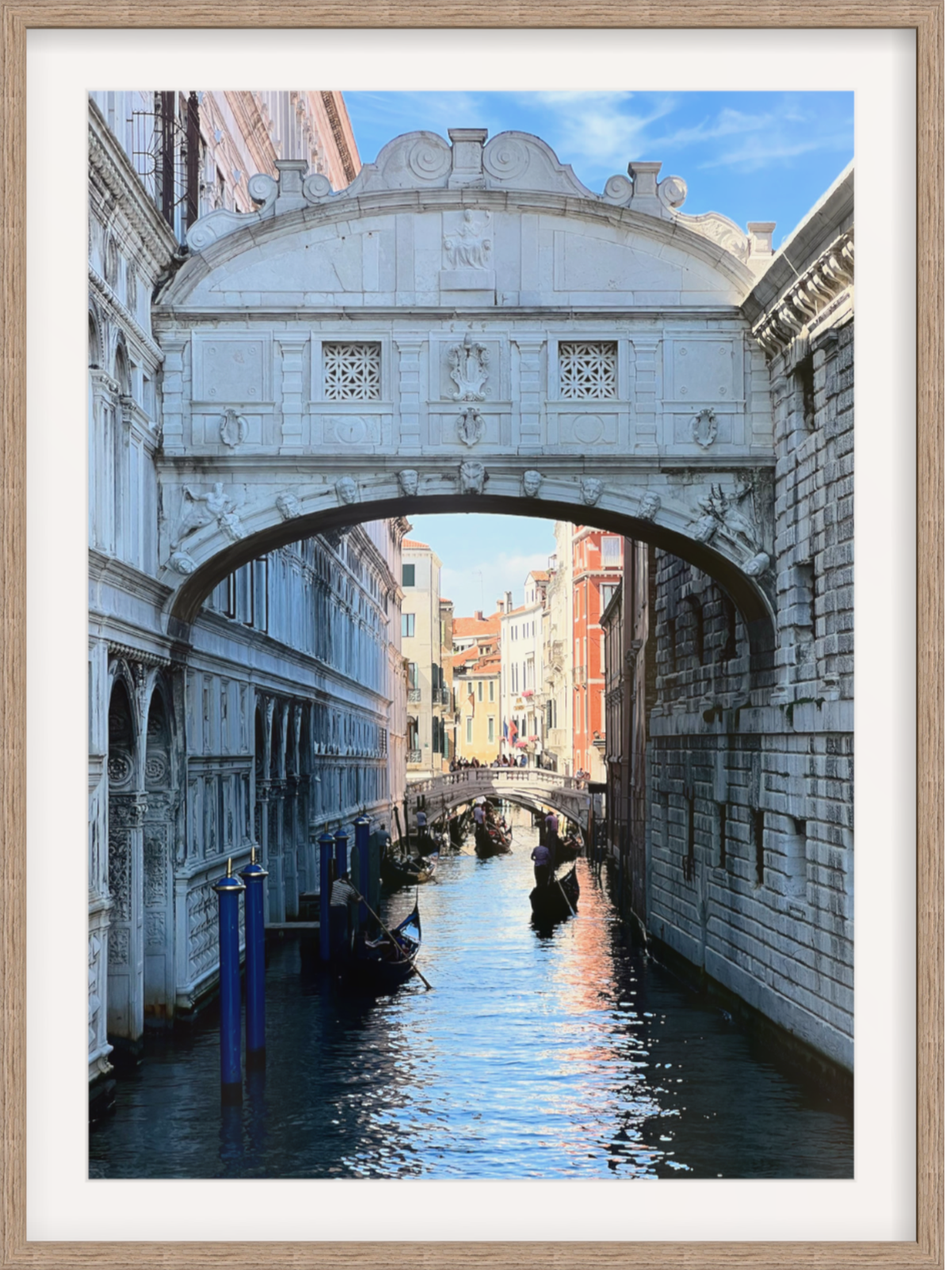 Venice canal wall art with light wood frame and wide white mat